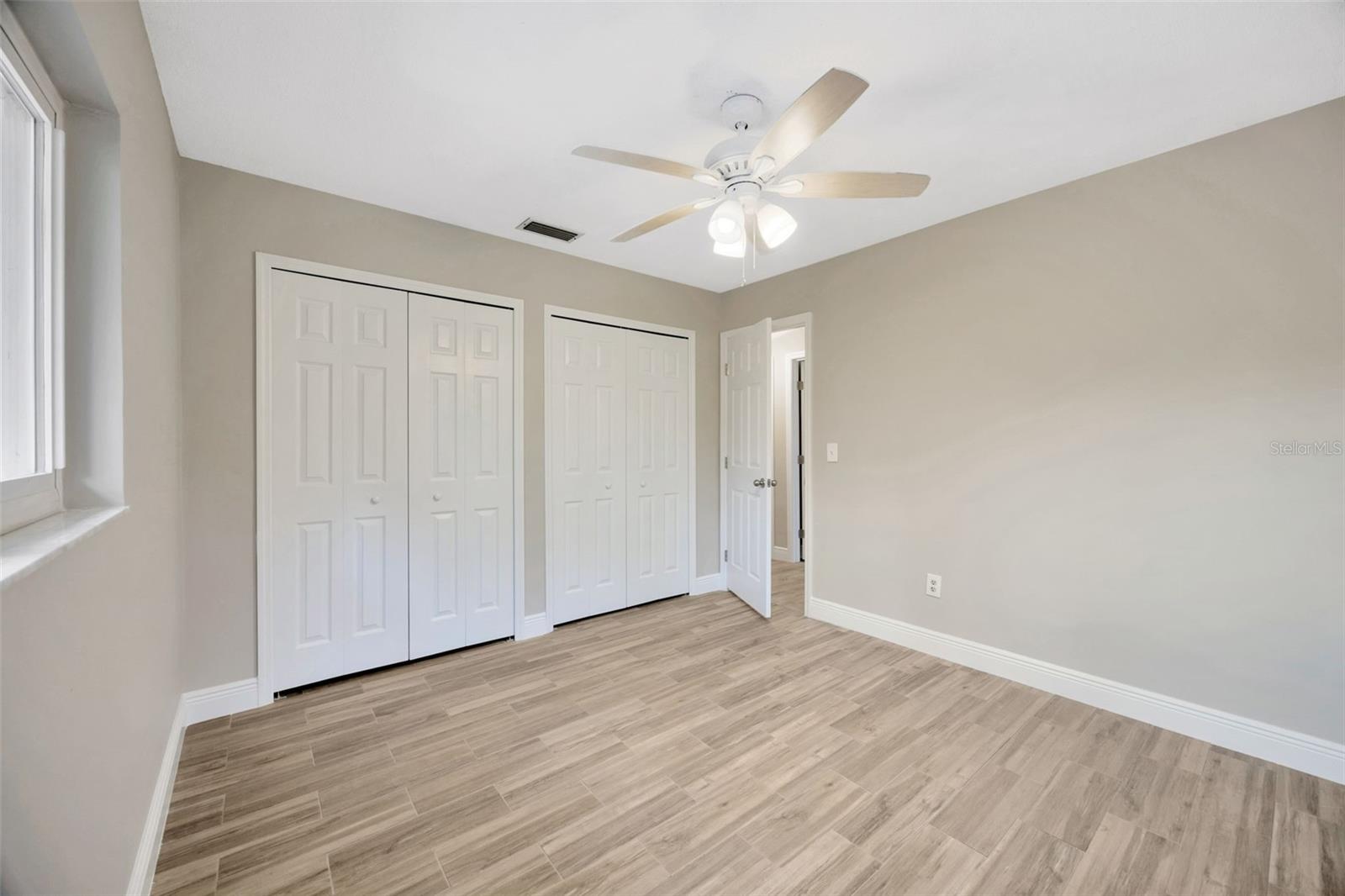 Dual sinks and plenty of cabinet space, with a linen closet right outside the door.
