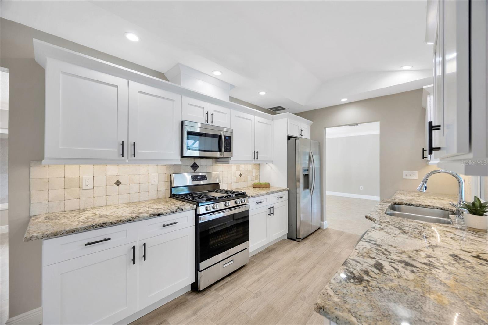 Brand new kitchen, soft close cabinets and drawers. Beautiful granite counter tops. Under cabinet lighting and neutral backsplash.