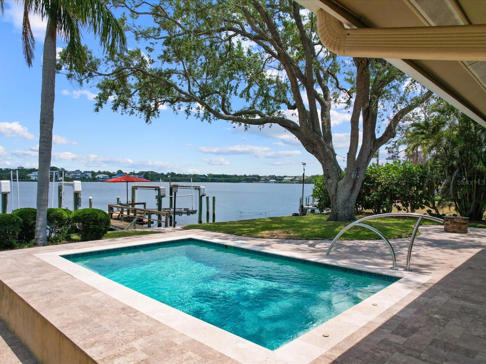 Pebble tec with travertine pool deck