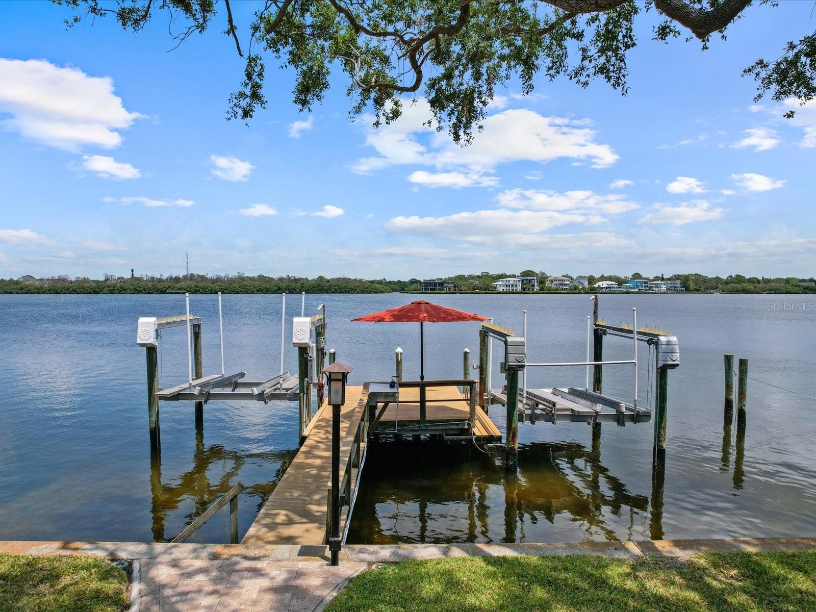 Boat dock with a lift for a boat and one for 2 jetskis