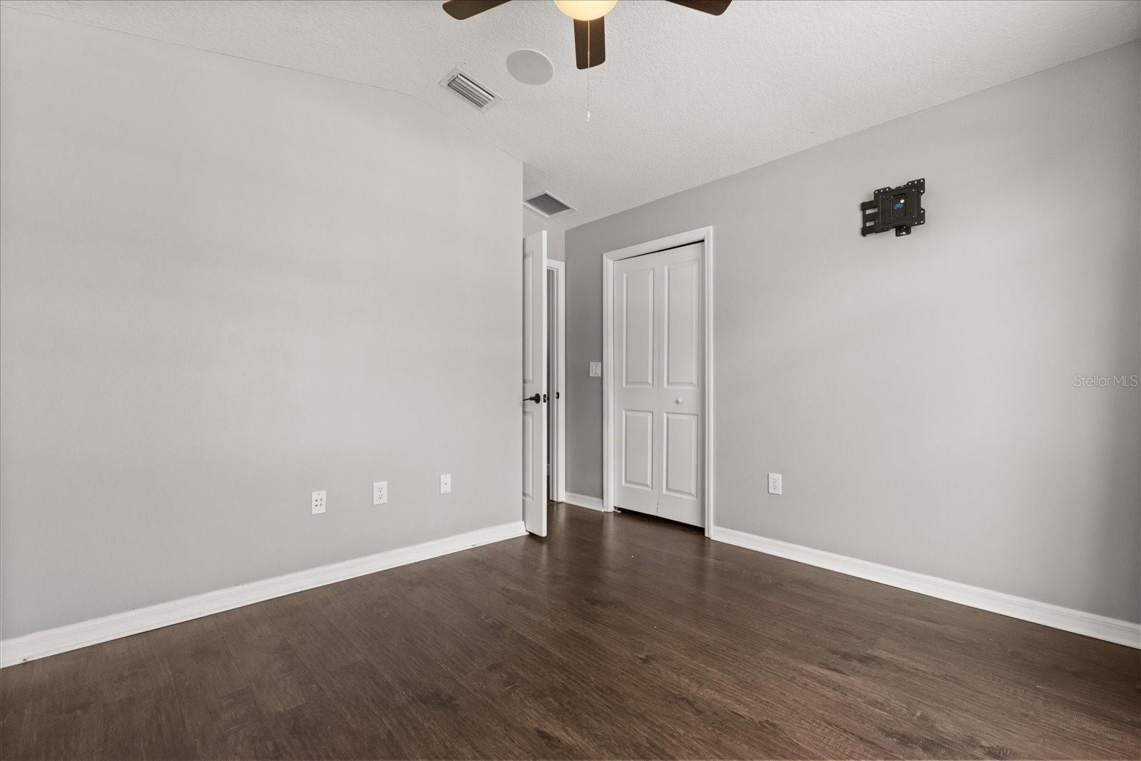 Third bedroom has ceiling fan and bright window