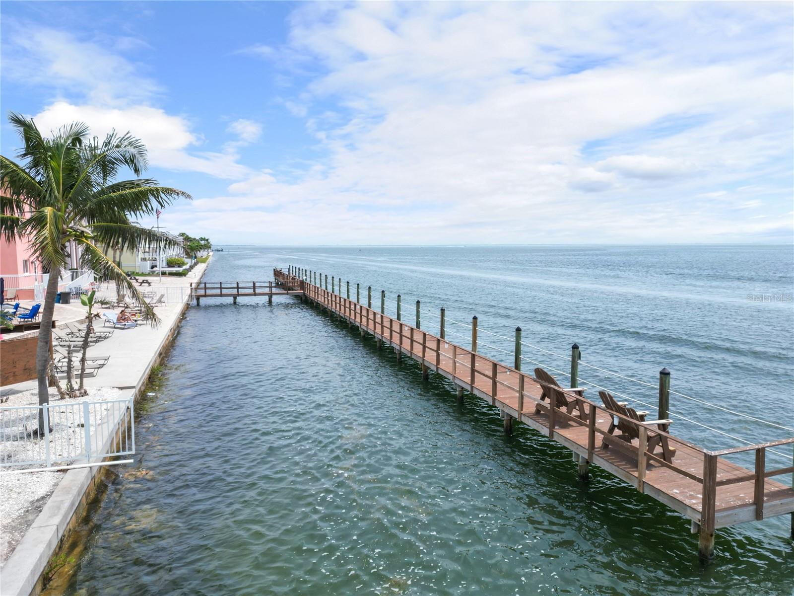 Pier with open water by the pool and clubhouse