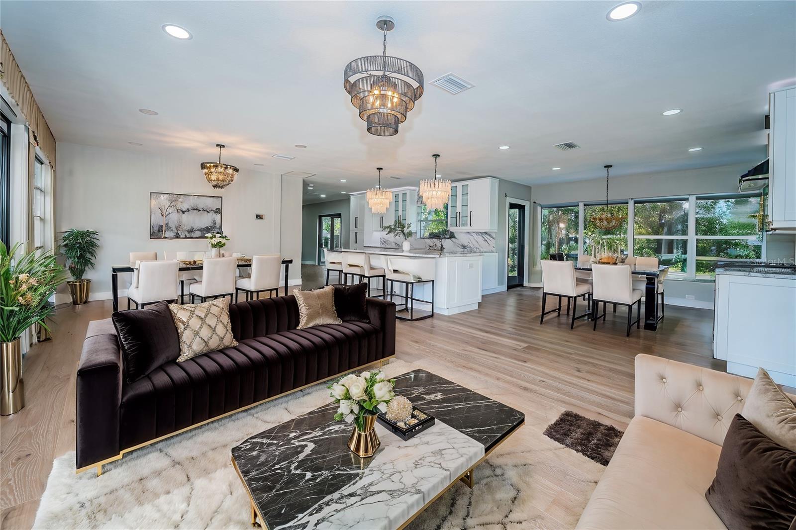 Virtually staged Living Area overlooking the Kitchen and Dining area