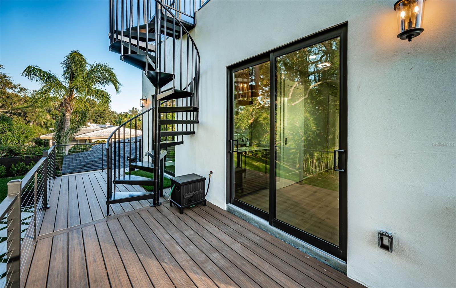 Upper level balcony with spiral staircase to the rooftop retreat!