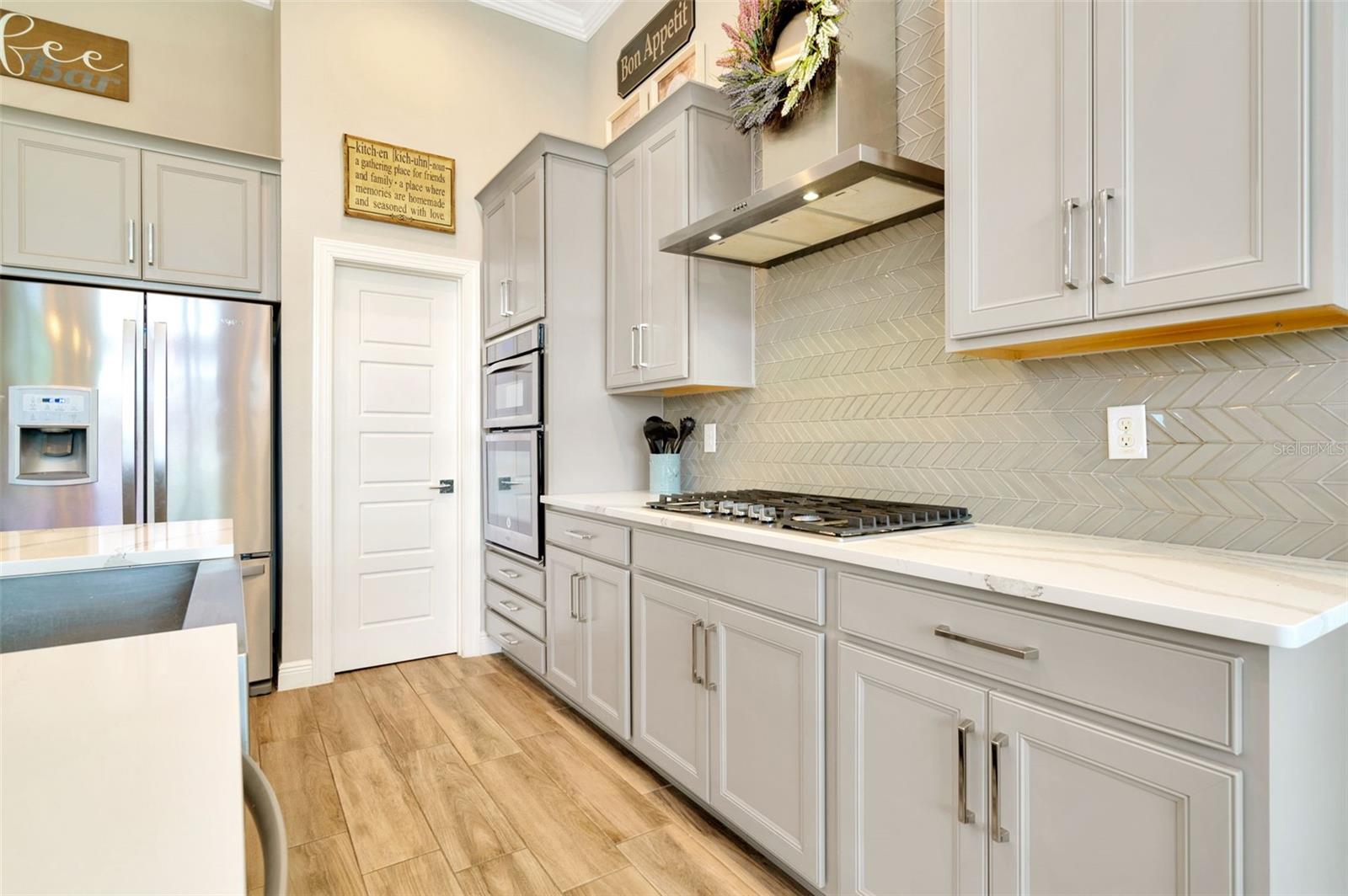 Walk in pantry is just off the kitchen and features custom shelving.