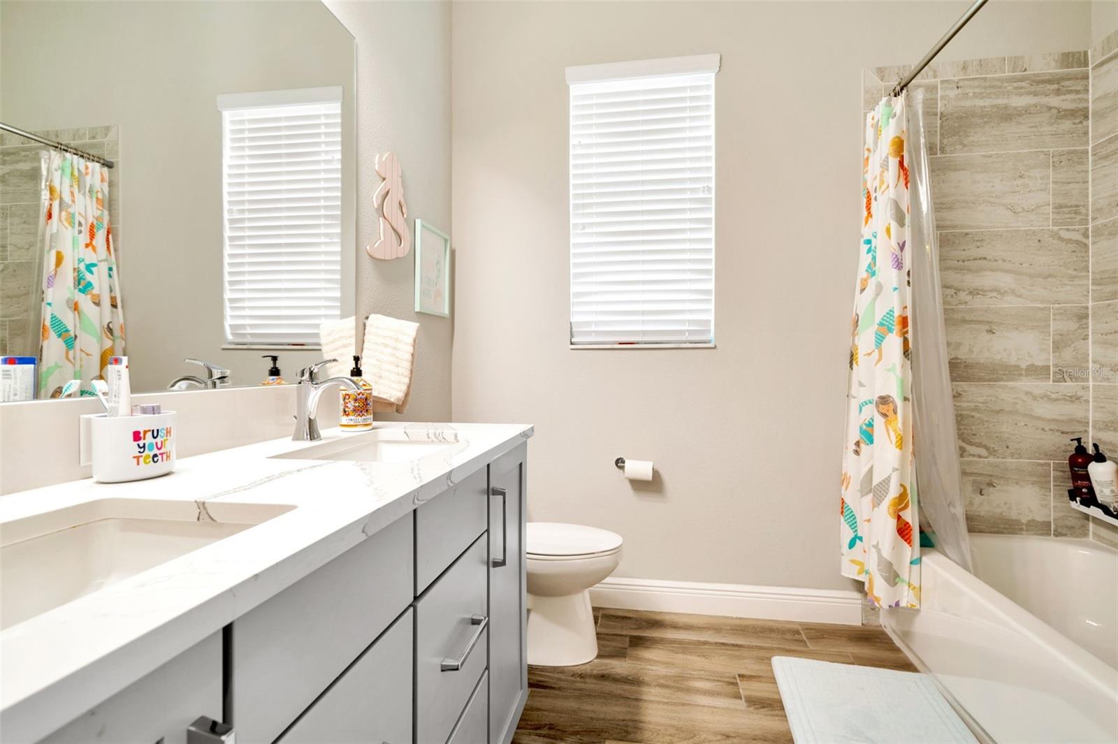 Bath between bedroom 2 and 3 featuring double vanity.