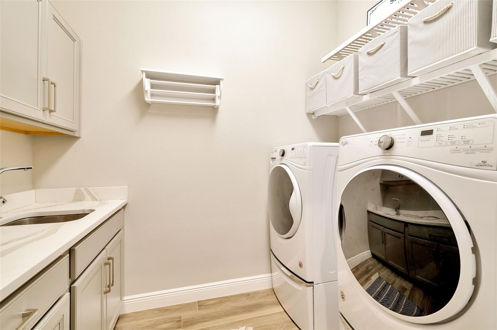 Laundry room with full sink and more than enough counter space.