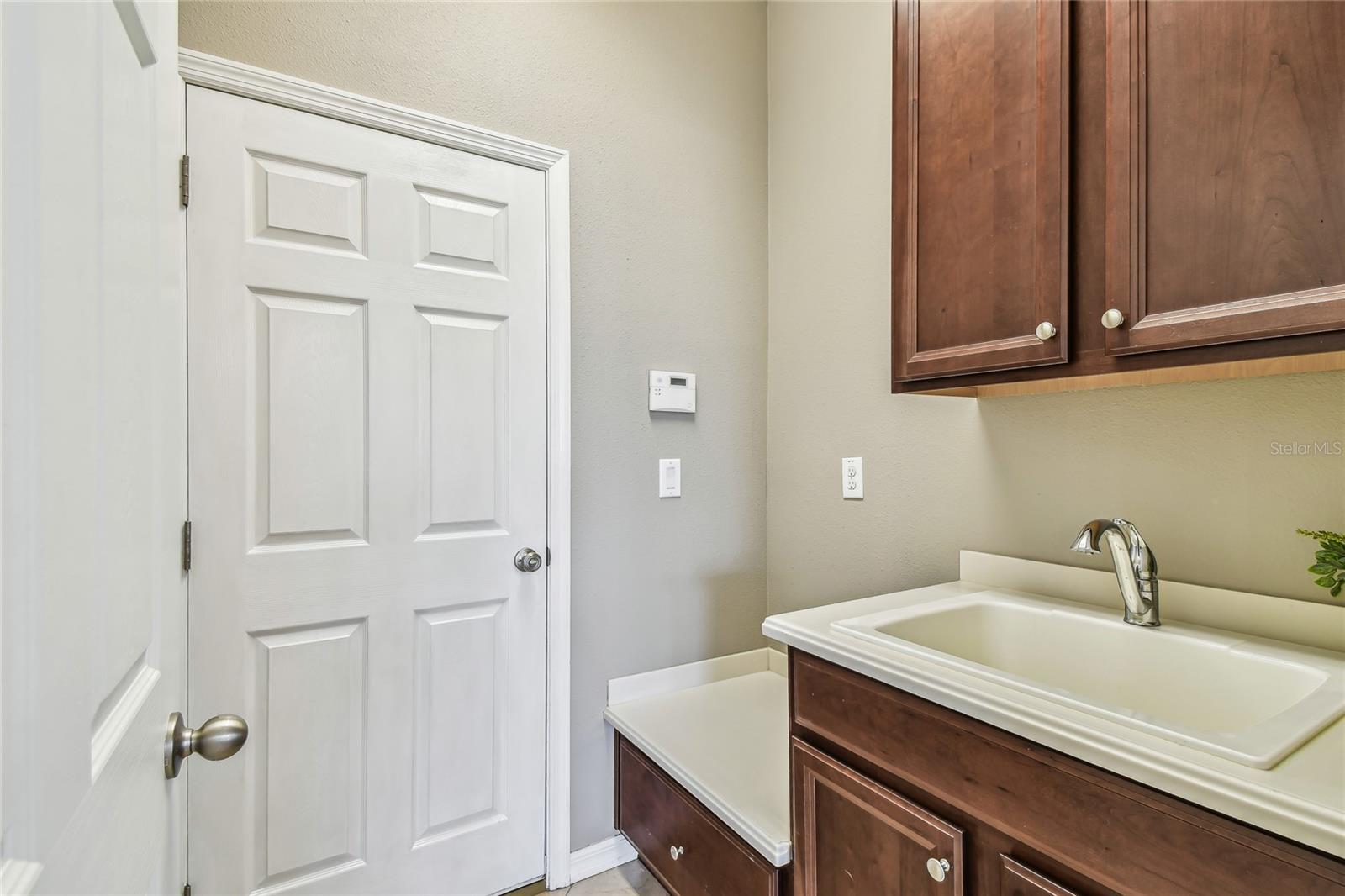 entrance from garage, wash station & storage