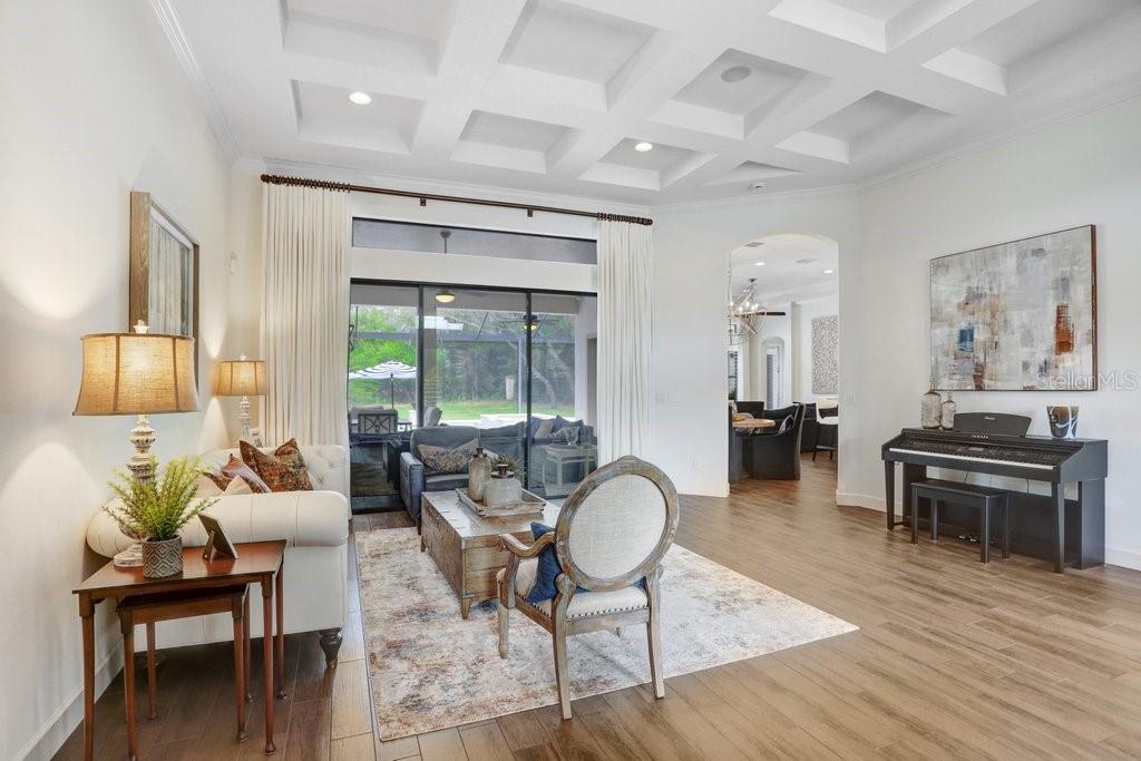 Formal living room connecting into breakfast nook and kitchen.