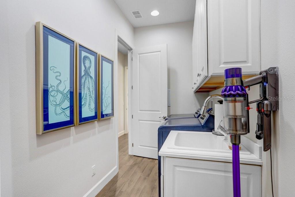 Laundry room off kitchen connecting to Bedroom corridor.