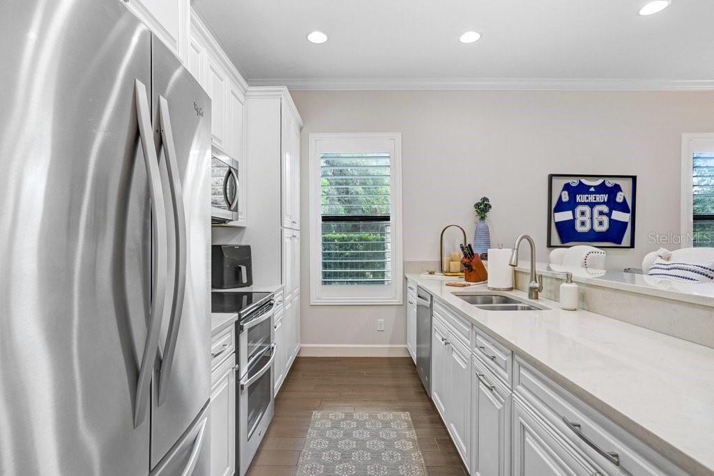 Full kitchen in bonus room with Whirlpool appliances.