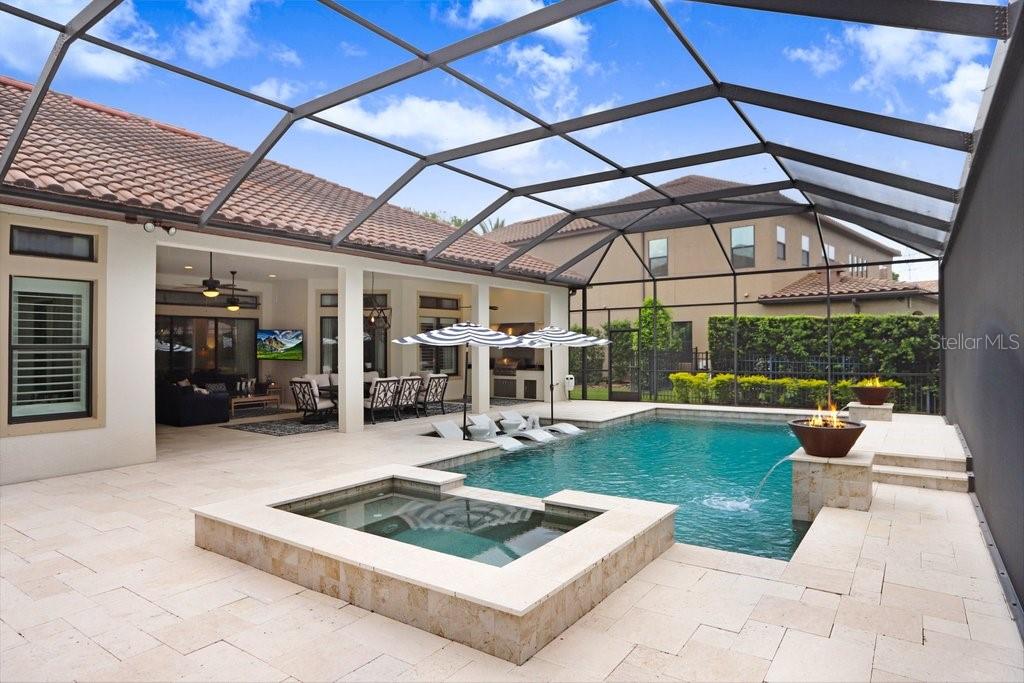 Saltwater pool and spa with spillover and fire features.