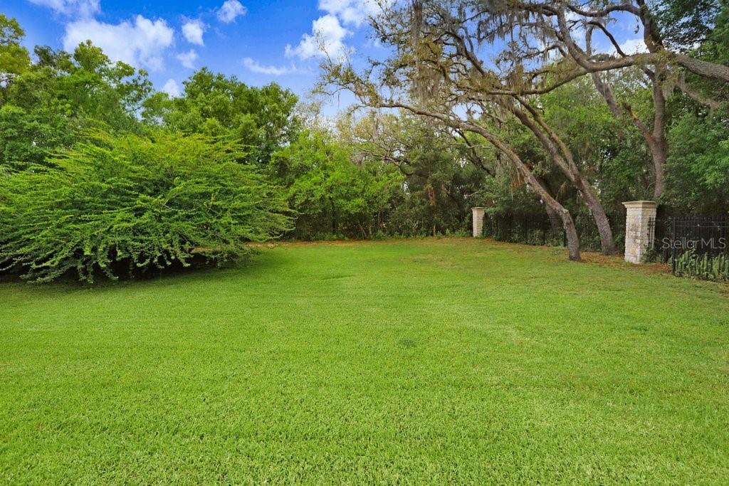 Backyard of home beyond screened in lanai.
