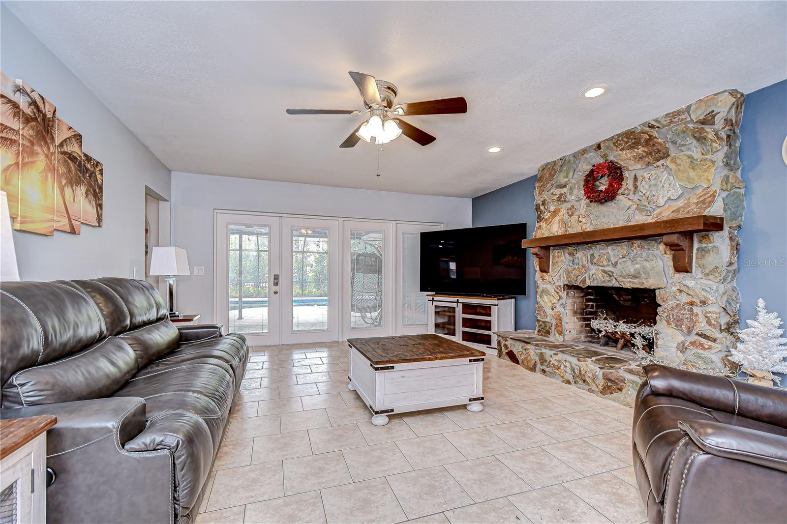 This family room boasts french doors overlooking the pool!