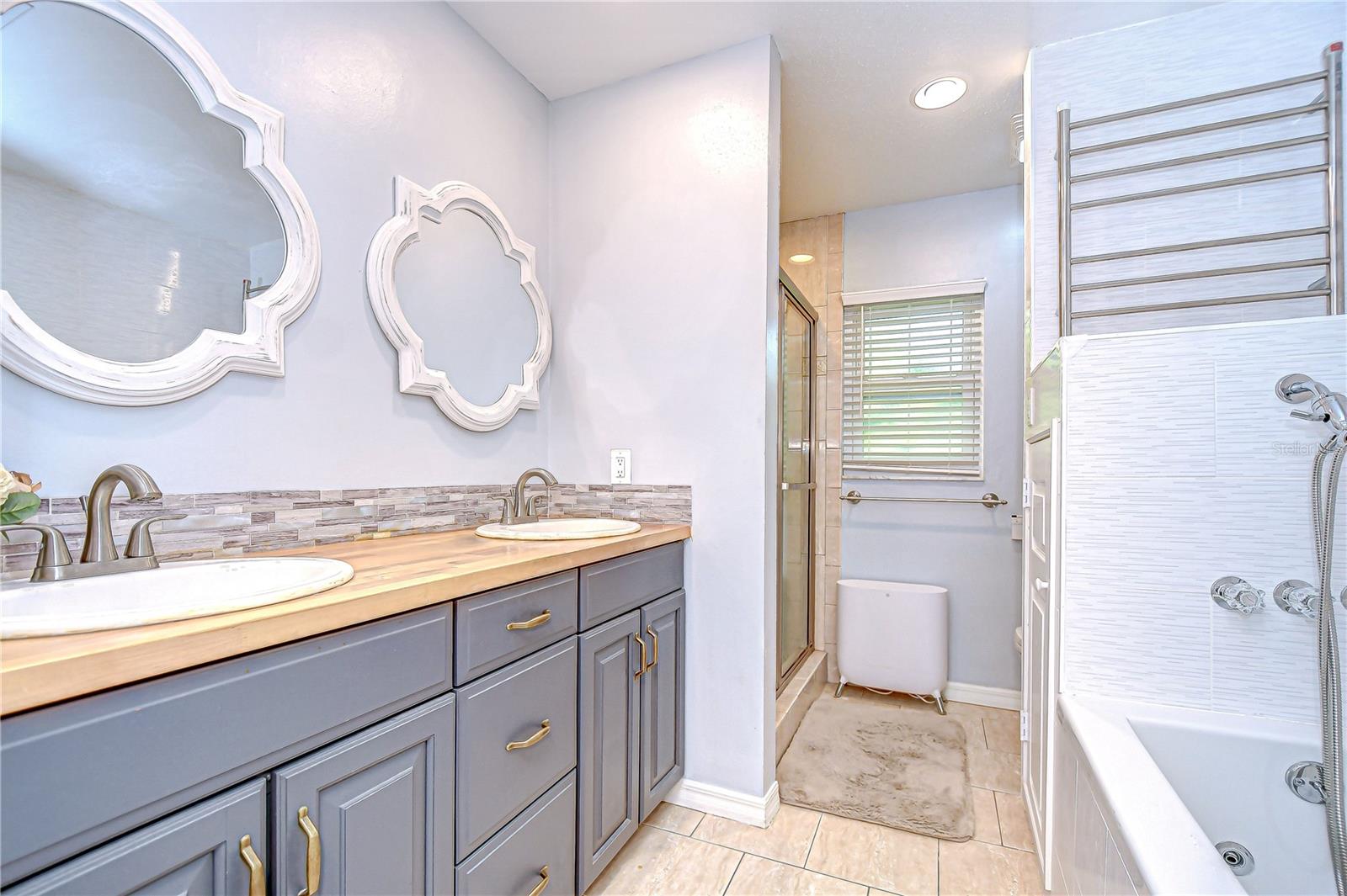Primary en-suite includes dual sinks, walk-in shower, Hydro-massager whirlpool tub and Bio-Bidet!