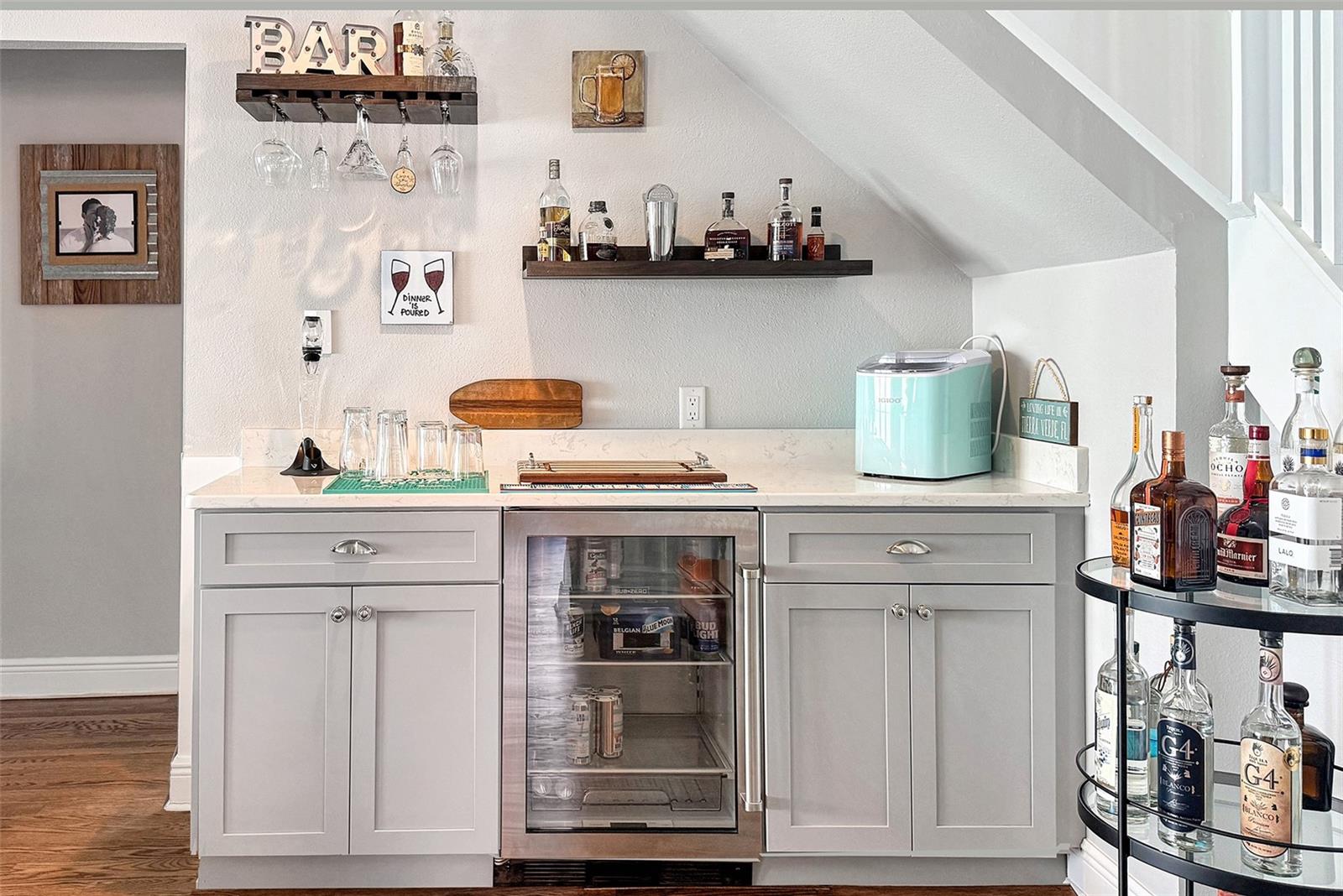 Centrally located libation station with beverage fridge.