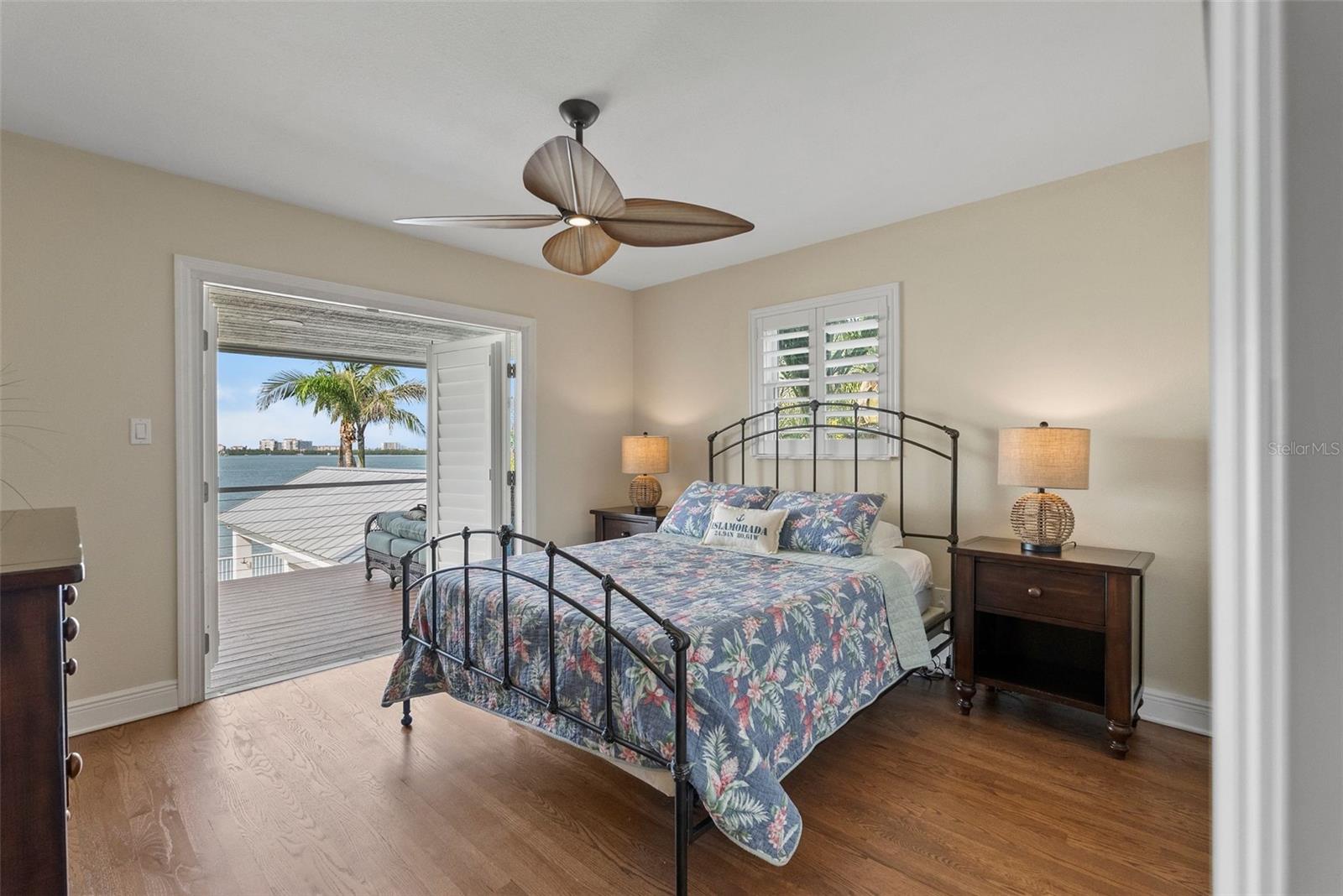 Waterside bedroom on main living level with deck access.
