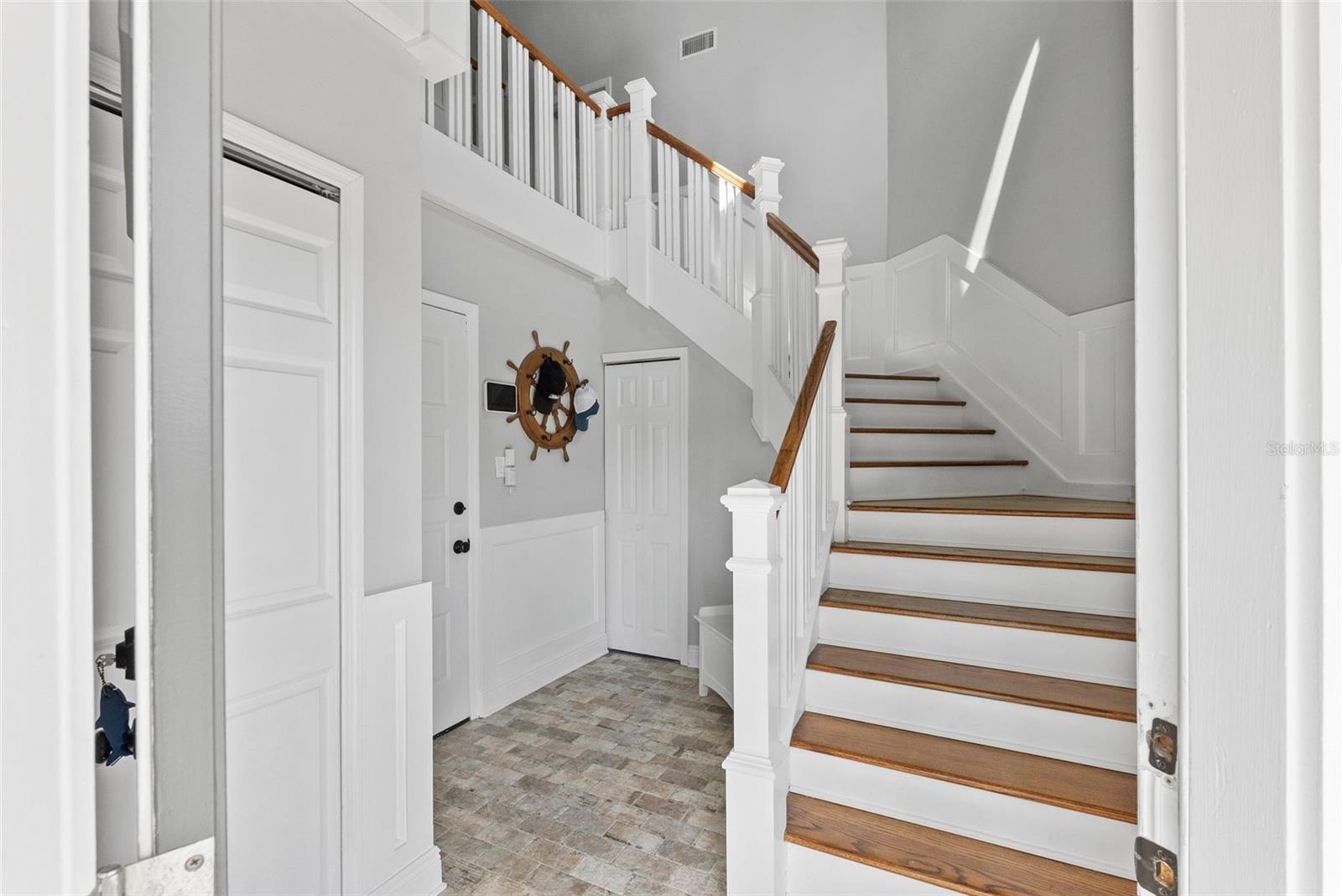 Gracious entry way with storage and garage access.