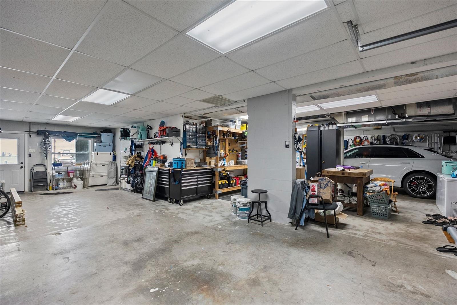 Huge garage with room for three cars plus a golf cart.
