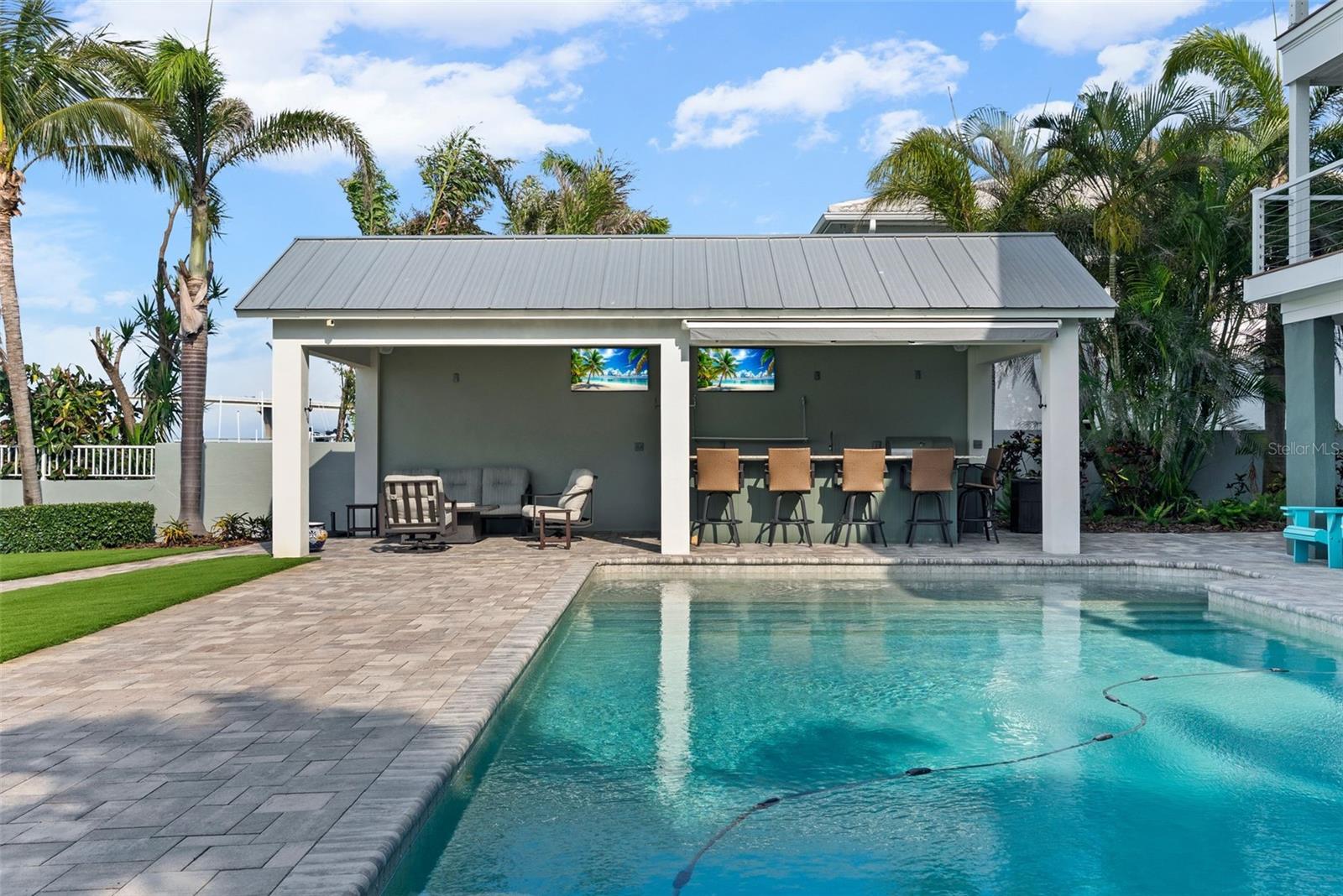 Incredible secondary covered outdoor living area with outdoor kitchen and Wolf grill.