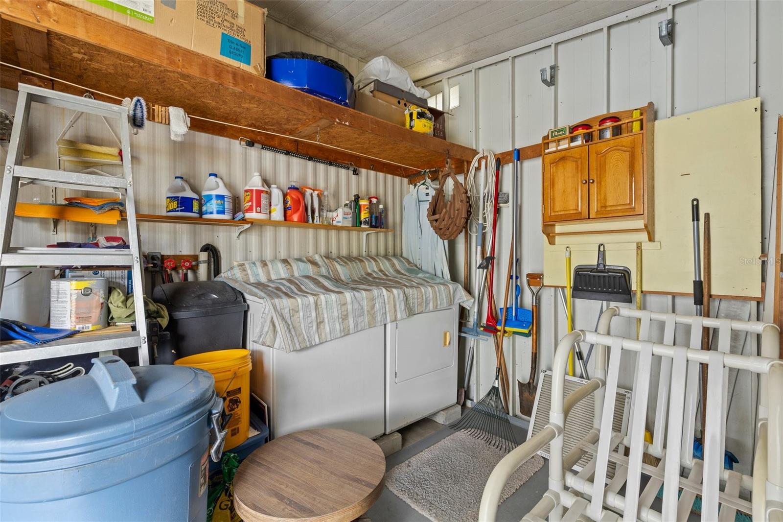 Shed can be accessed through covered car port for washer/dryer & tools
