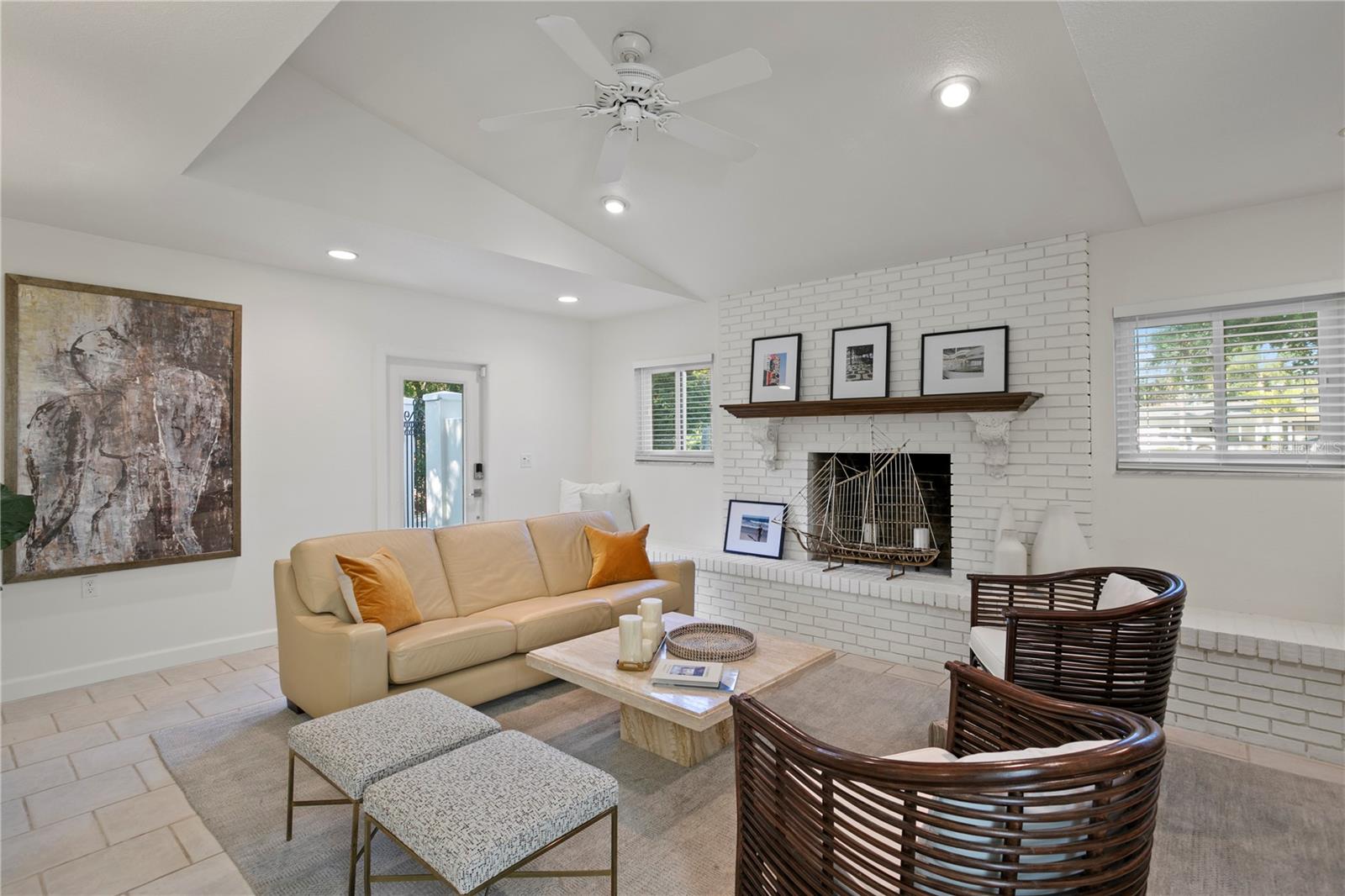 Adjacent to kitchen is the sunken family room complete with a fireplace, creating a warm and inviting atmosphere.