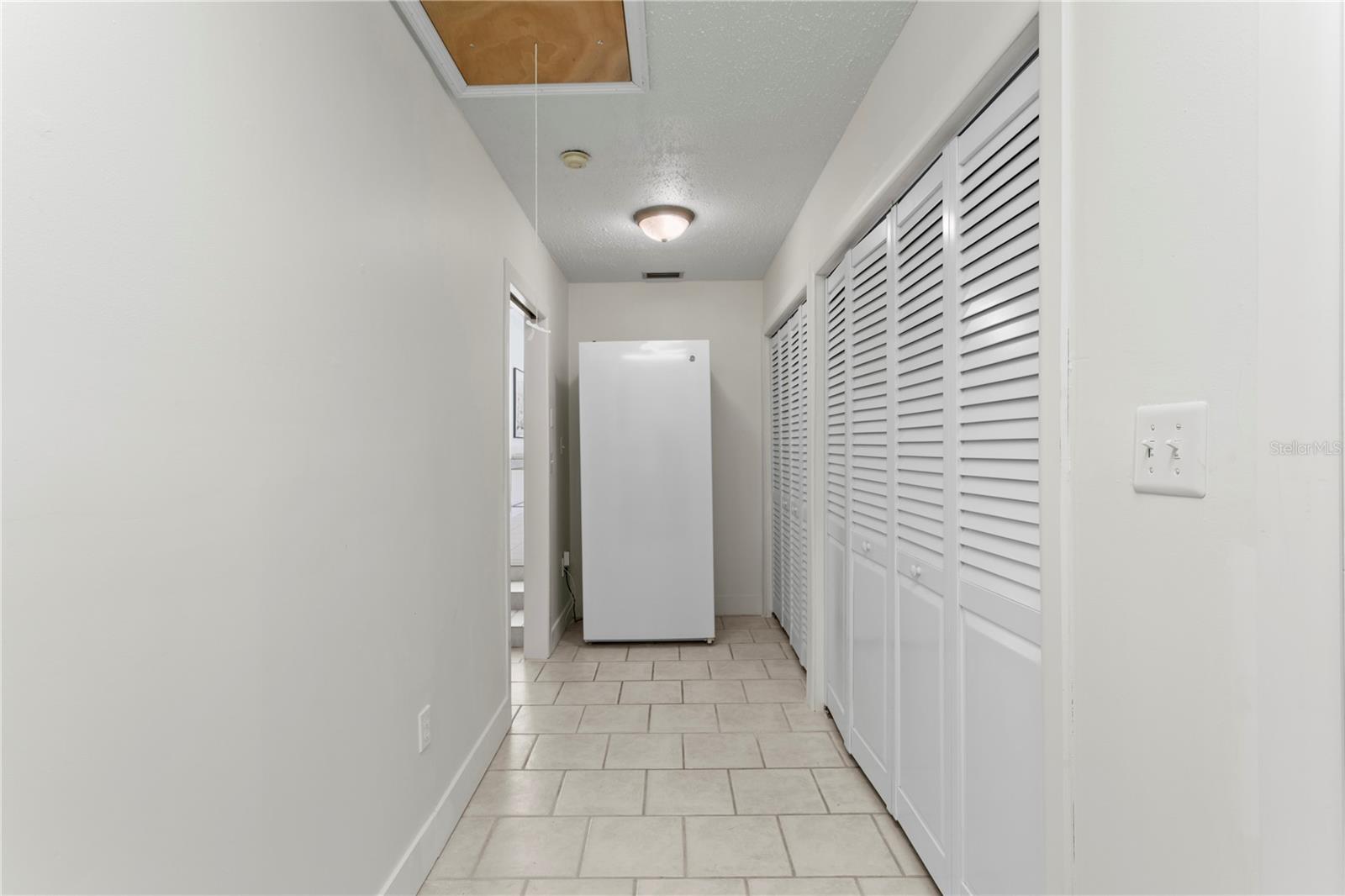 Located off of the sunken family, this room features extra storage, a full size washer/dryer and freezer