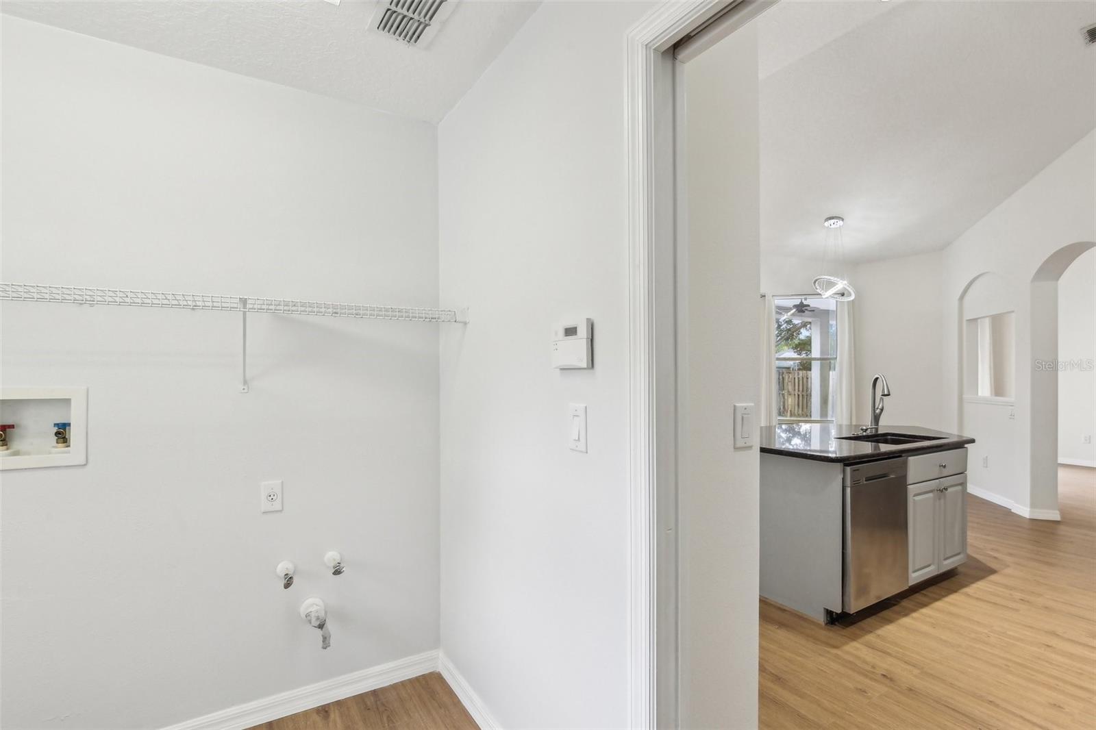 LAUNDRY ROOM CONVENIENTLY LOCATED OFF KITCHEN WASTES NO SPACE WITH A POCKET DOOR