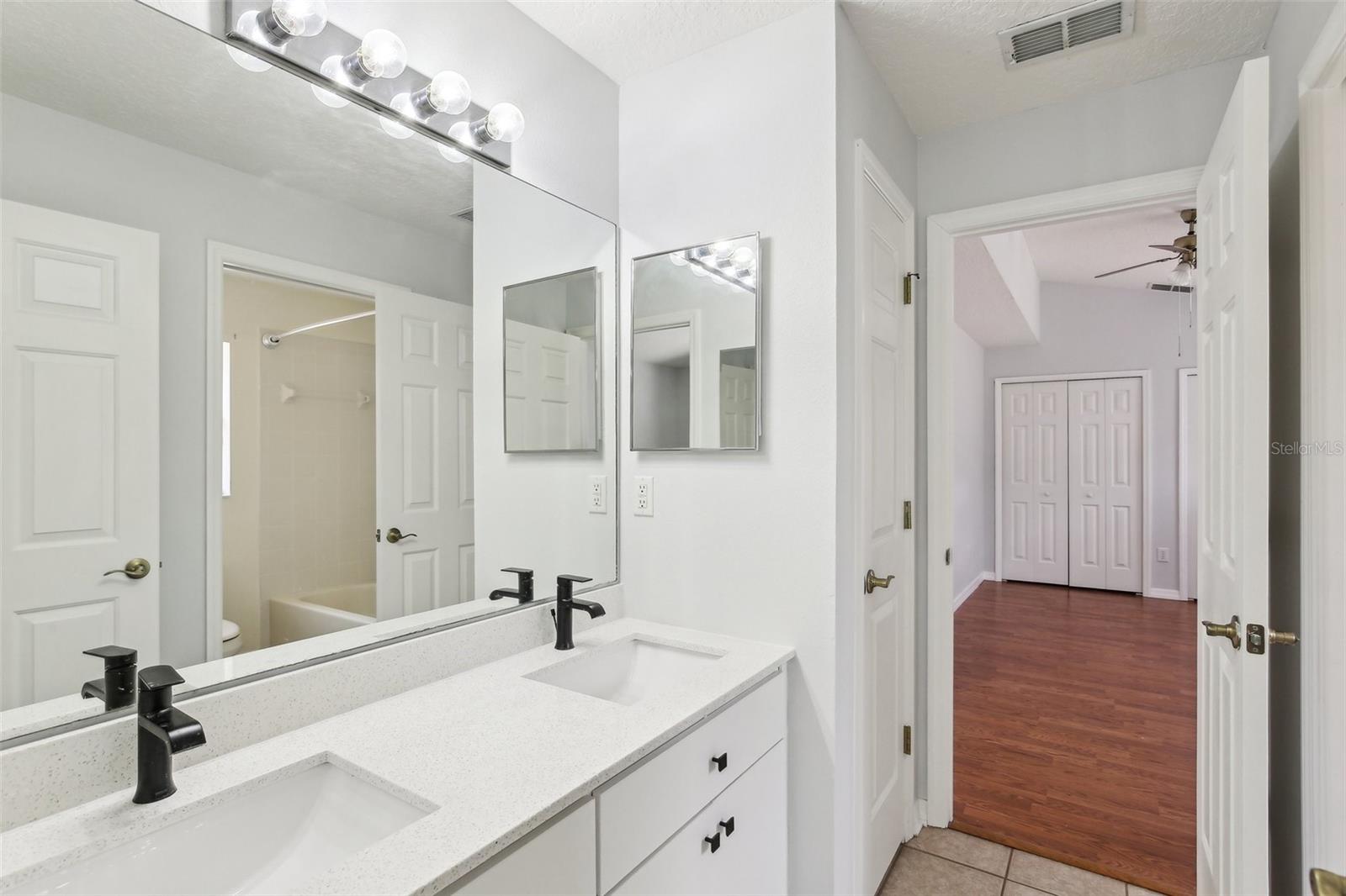 BEDROOM 2 AND 3 SHARE A JACK AND JILL BATHROOM WITH   TUB AND DUAL SINK COUNTERS