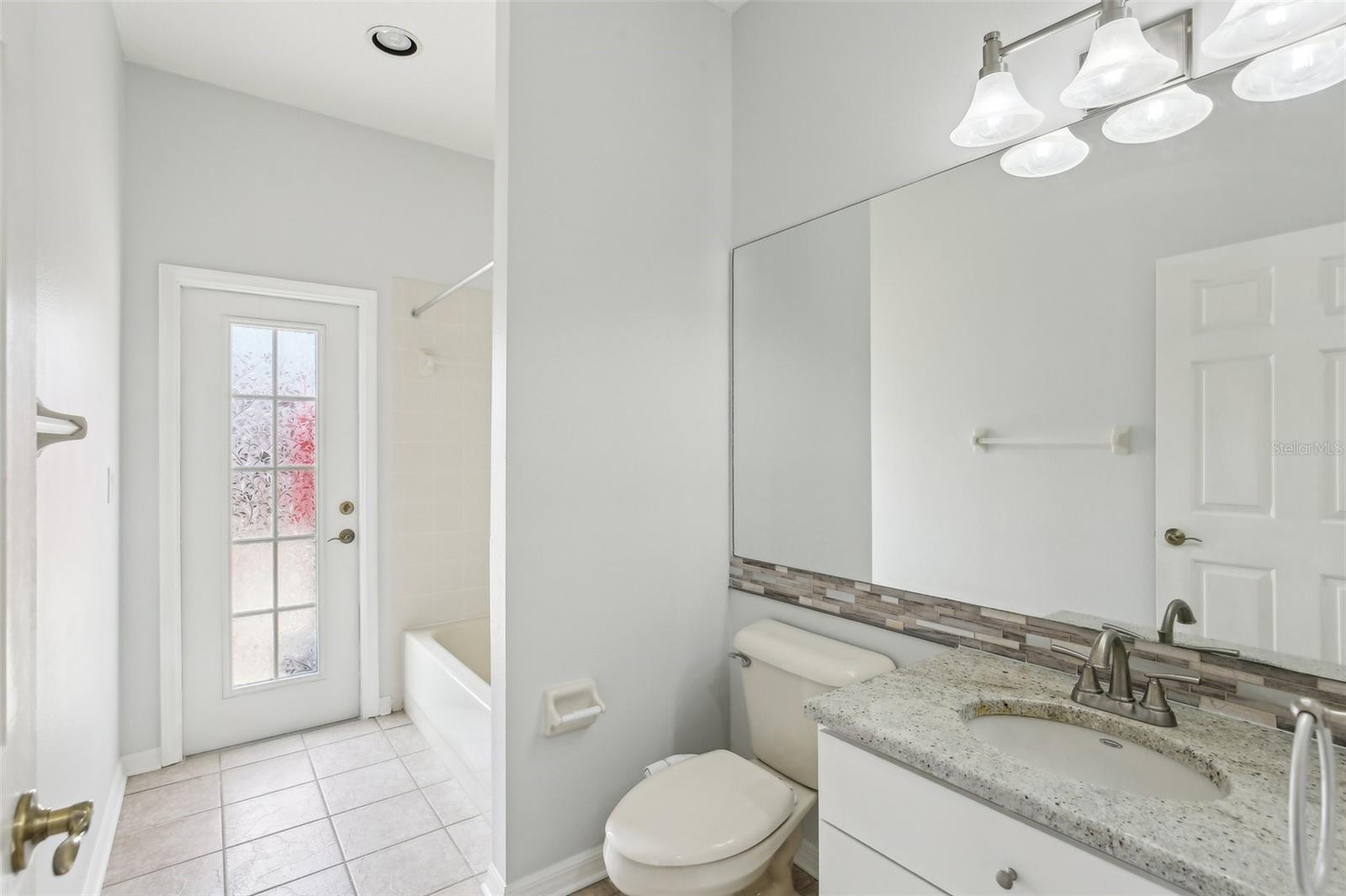 BATHROOM 3 HAS STEP-IN TUB AND DOOR TO OUTSIDE. MAKE THIS YOUR POOL BATH AFTER YOU ADD A POOL!