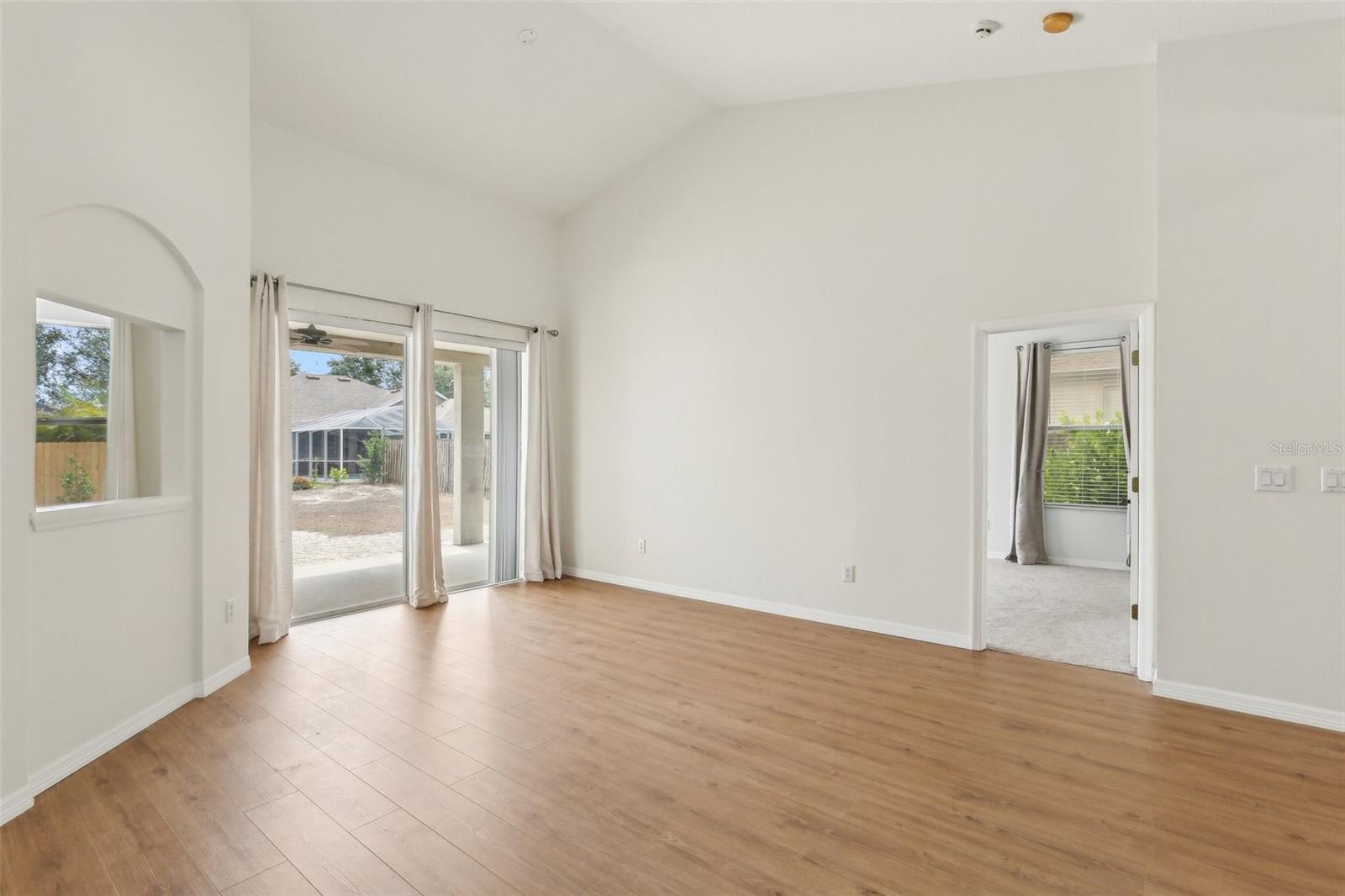 FORMAL LIVING ROOM. DOOR LEADS TO PRIMARY SUITE