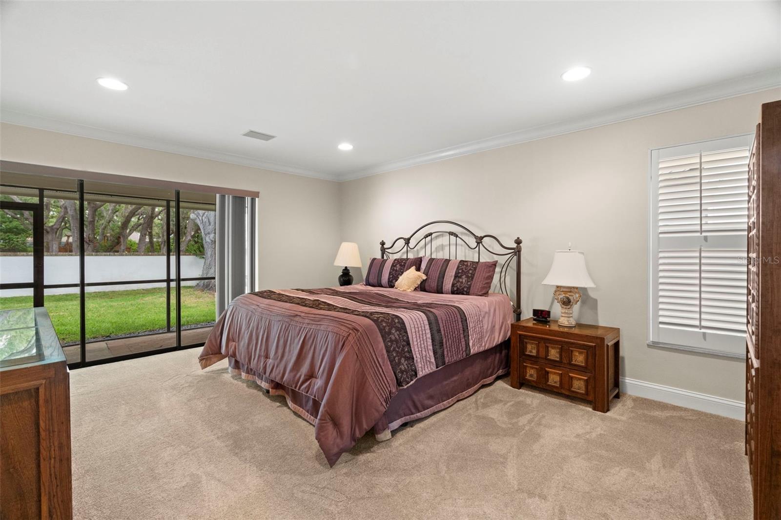 Primary Bedroom has sliders to pool patio.