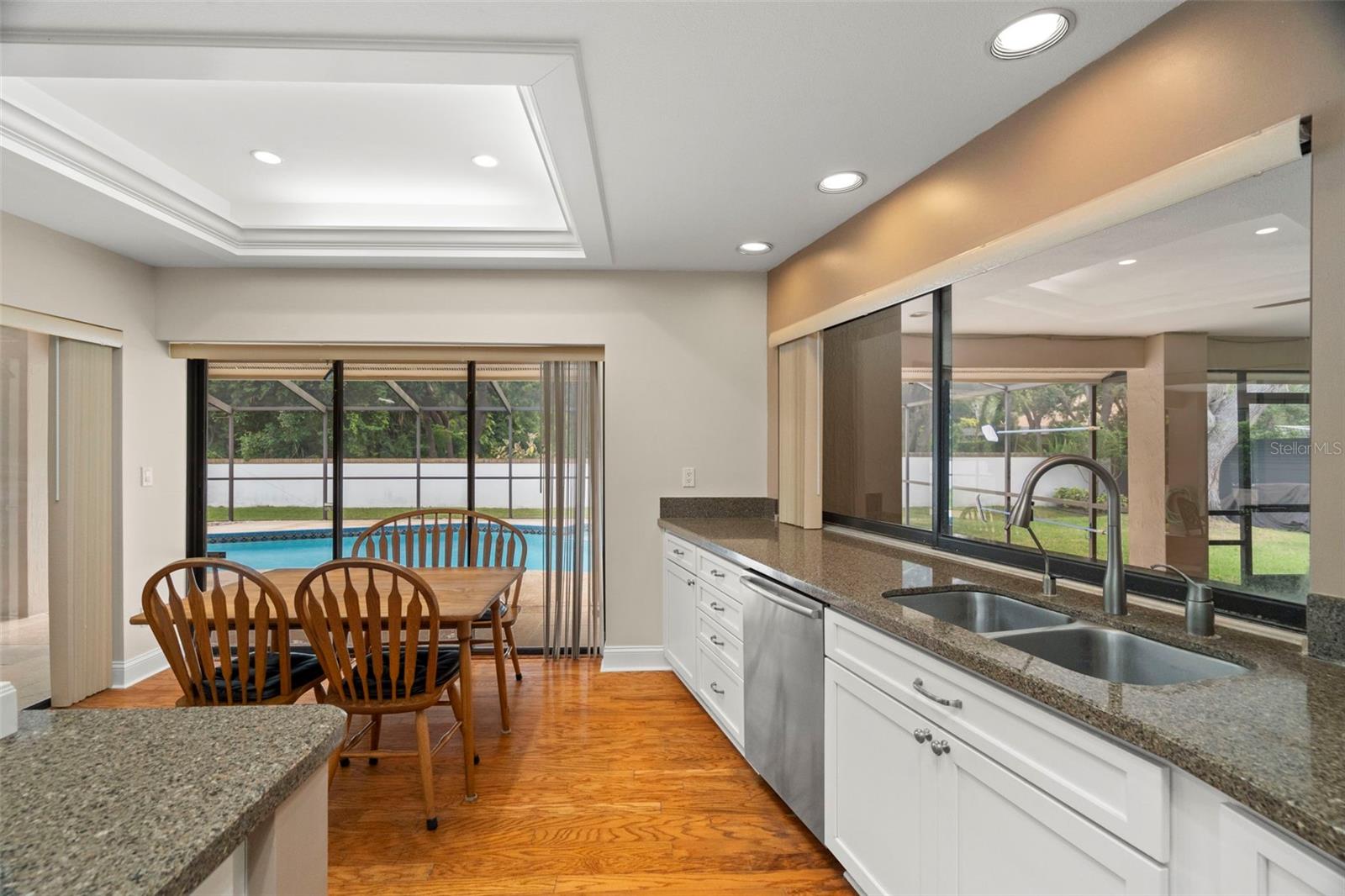 Spacious kitchen with new appliances, under counter microwave, and large nook overlooking the pool and patio.