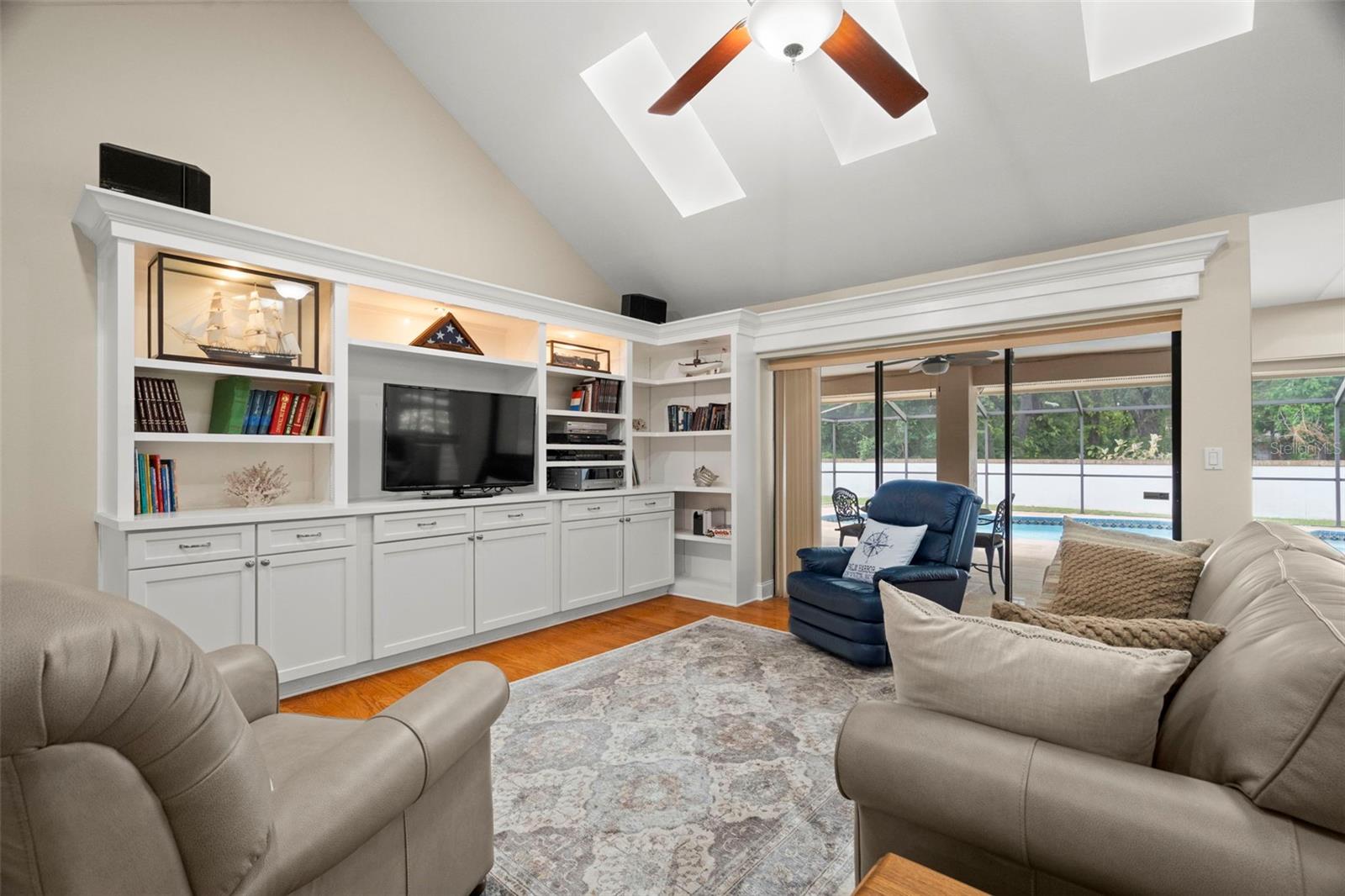Family Room with built-in entertainment shelves ; home wired for surround sound.