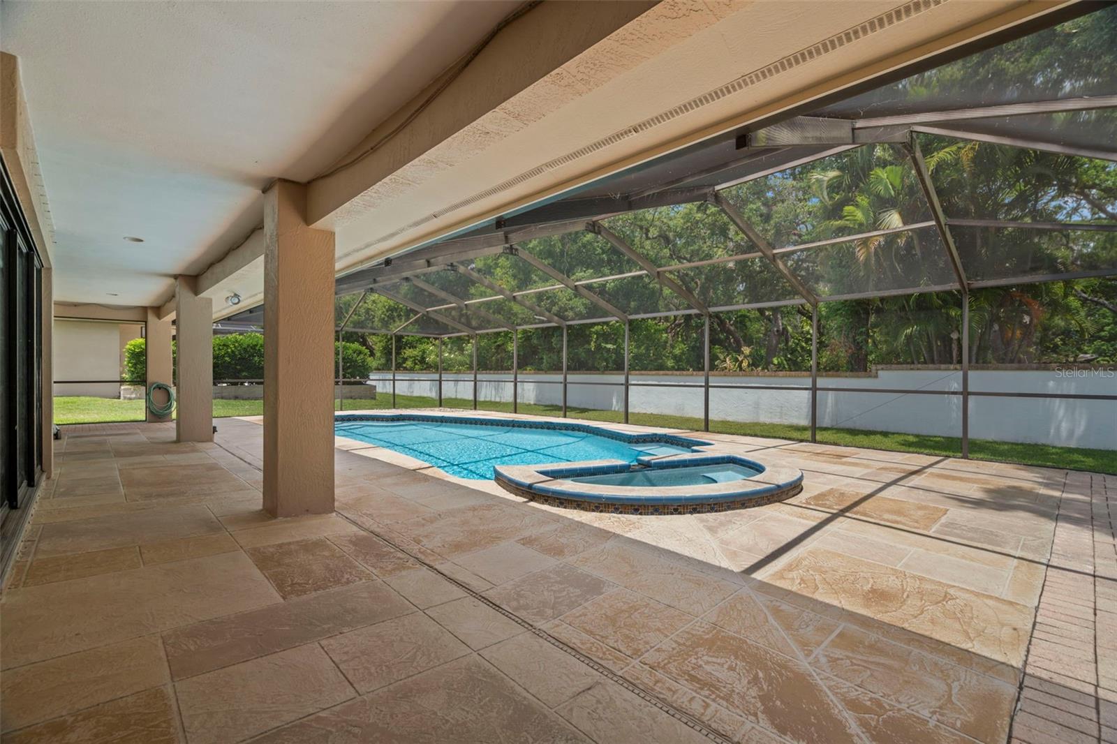 Covered pool patio extends the length of the house.