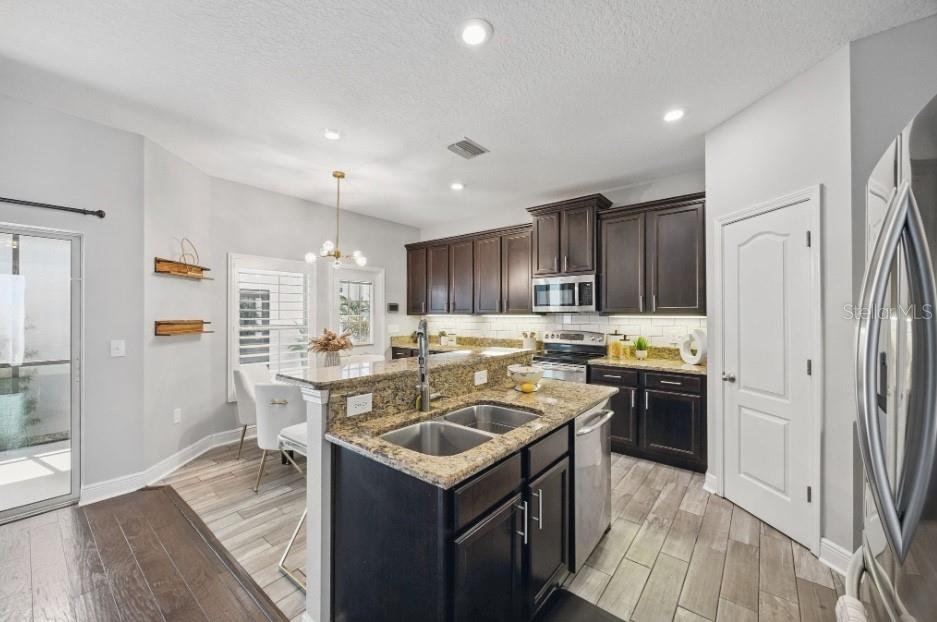 Island+large cabinetry wall with walk in pantry