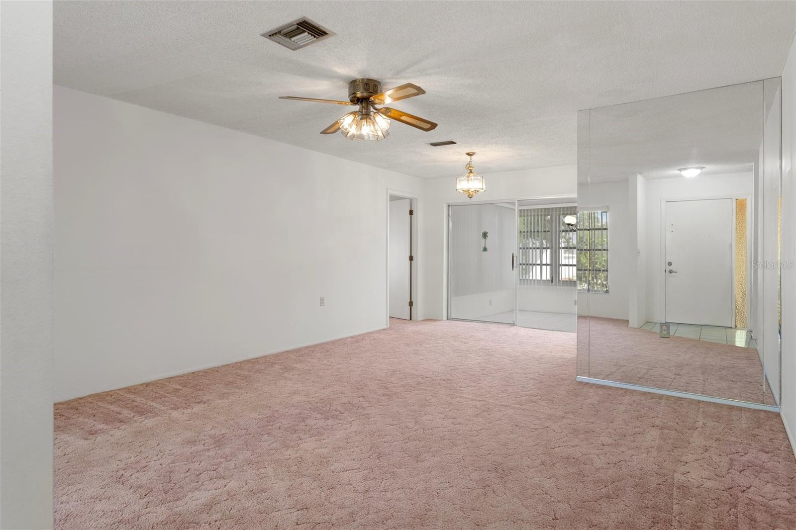 LIVING ROOM/DINING AREA & MIRRORED WALL