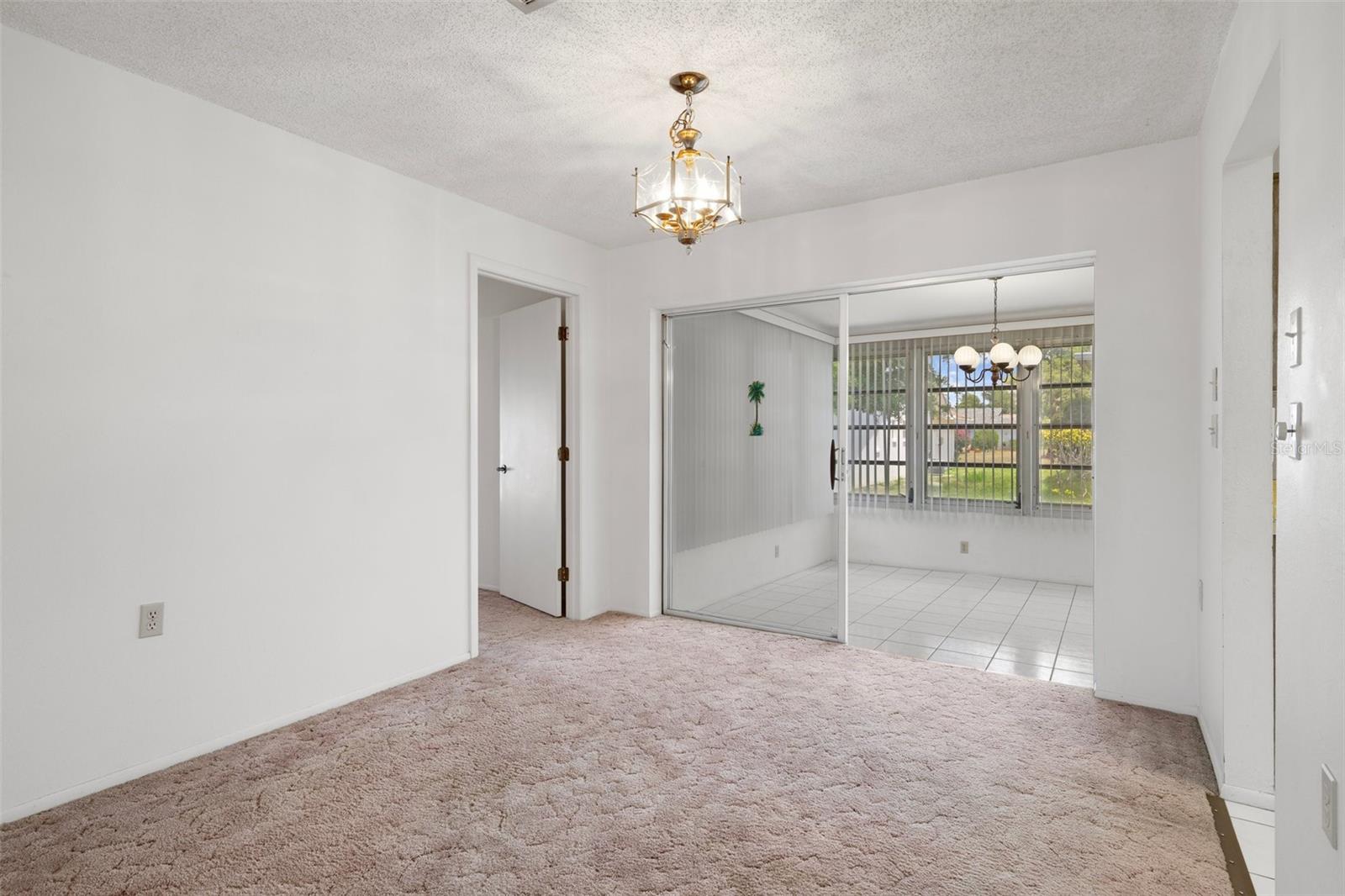 DINING AREA AND VIEW OF SUN ROOM