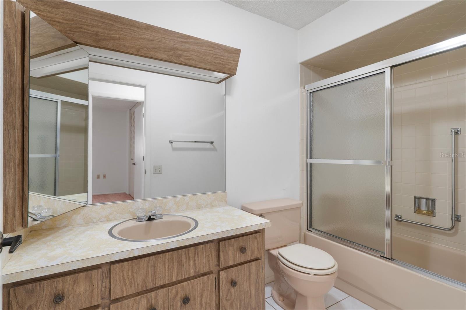 GUEST BATHROOM WITH TUB/SHOWER DOORS