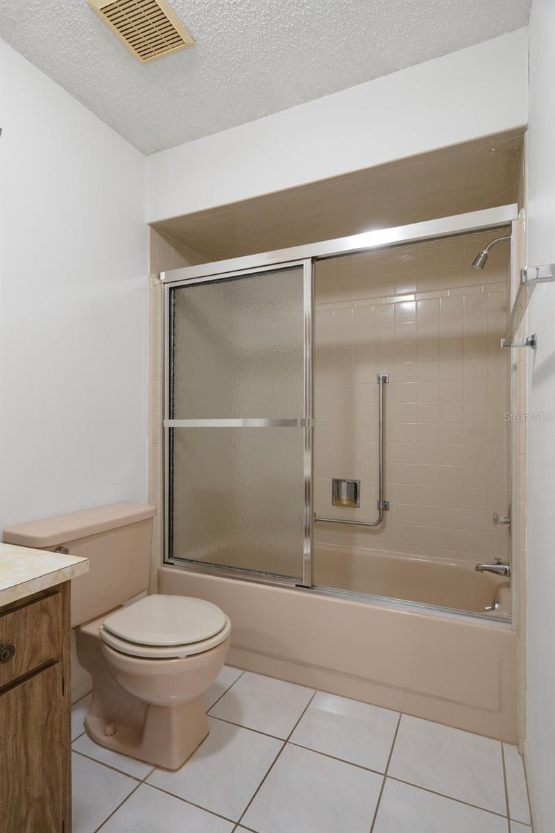 GUEST BATHROOM TUB AND TILE FLOOR