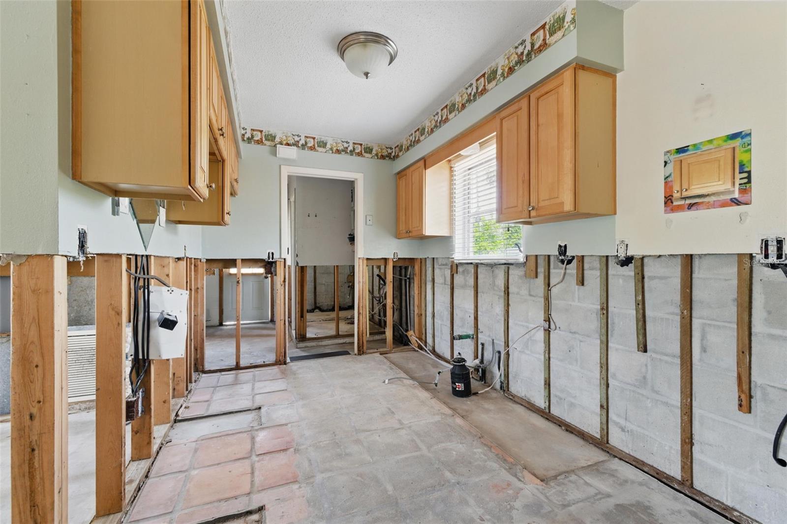 Kitchen and Hallway Leading to 2nd Bath and Garage Entry.