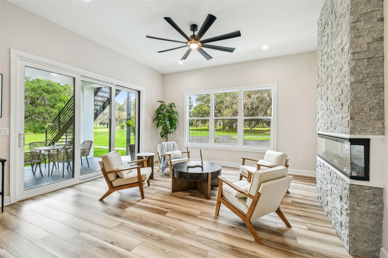 Great room with plenty of natural light from sliders and windows