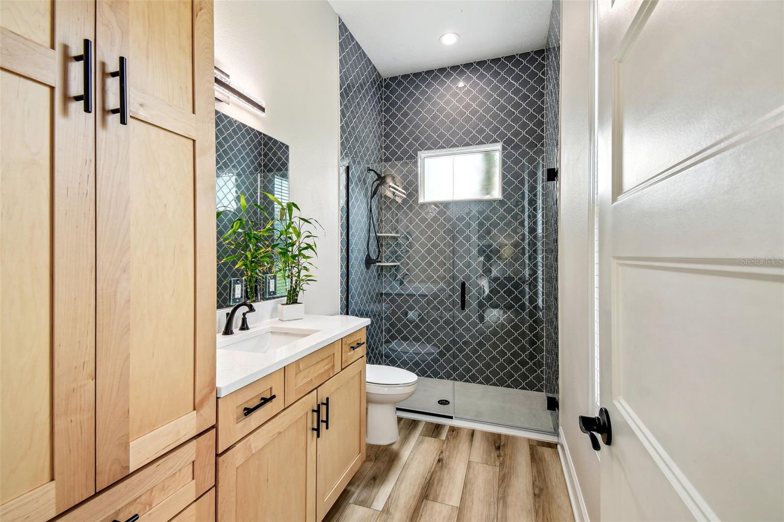 Bedroom 5 ensuite bathroom with floor to ceiling cabinet and walk-in shower