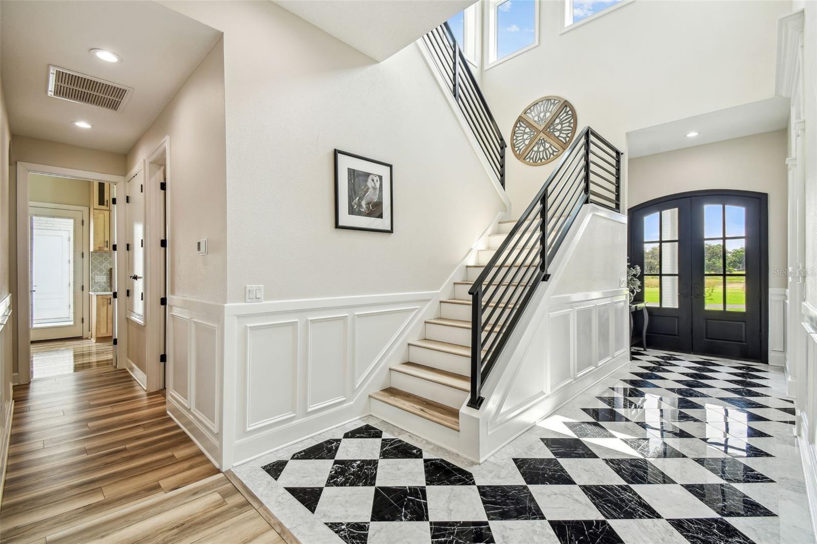 View of Foyer and  hallway of the powder room leading to mudroom/laundry room