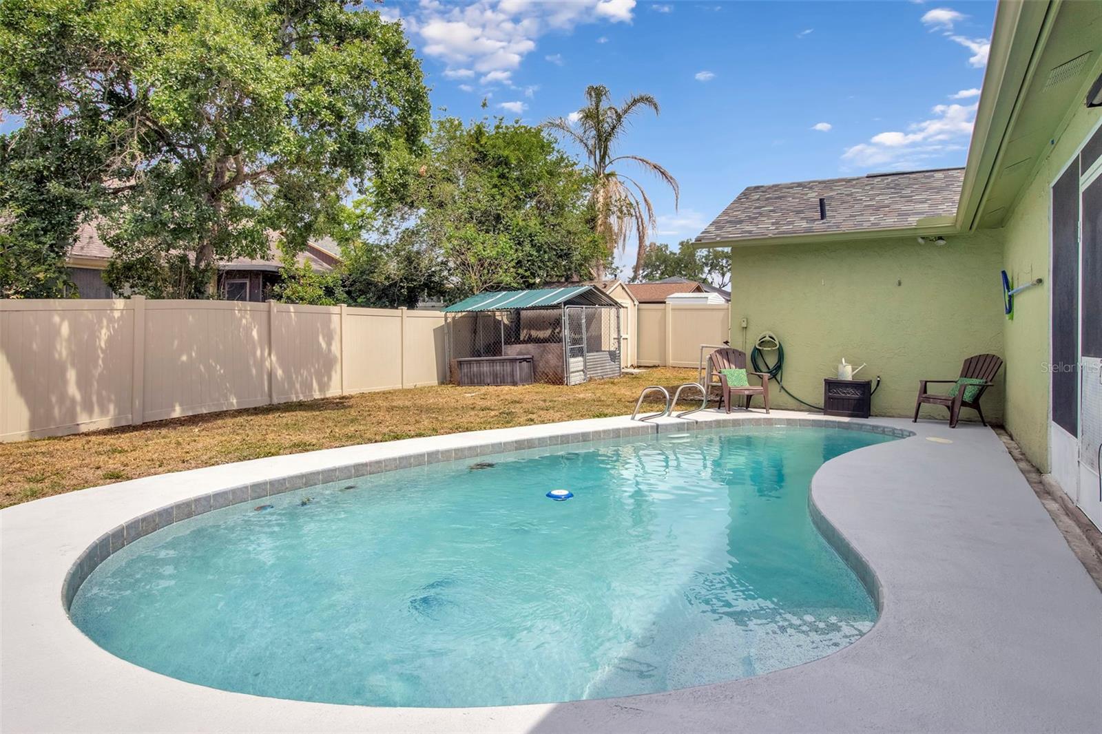 Back of home and pool, dog kennel and shed 1 of 2