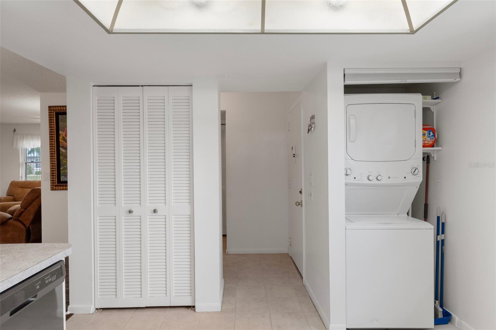 Pantry and Convenient Laundry Area with Stackable Washer & Dryer and Pull Down Shade