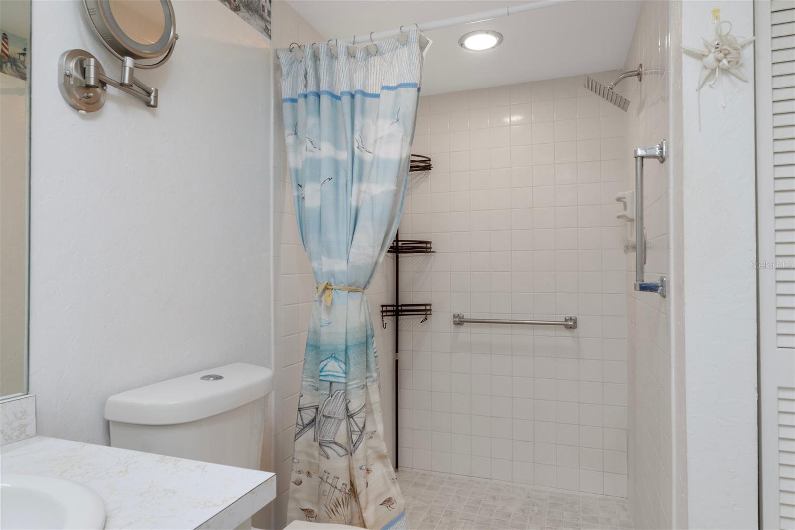 Primary Bath with NEWLY tiled Walk in Shower and NEW Shower Head
