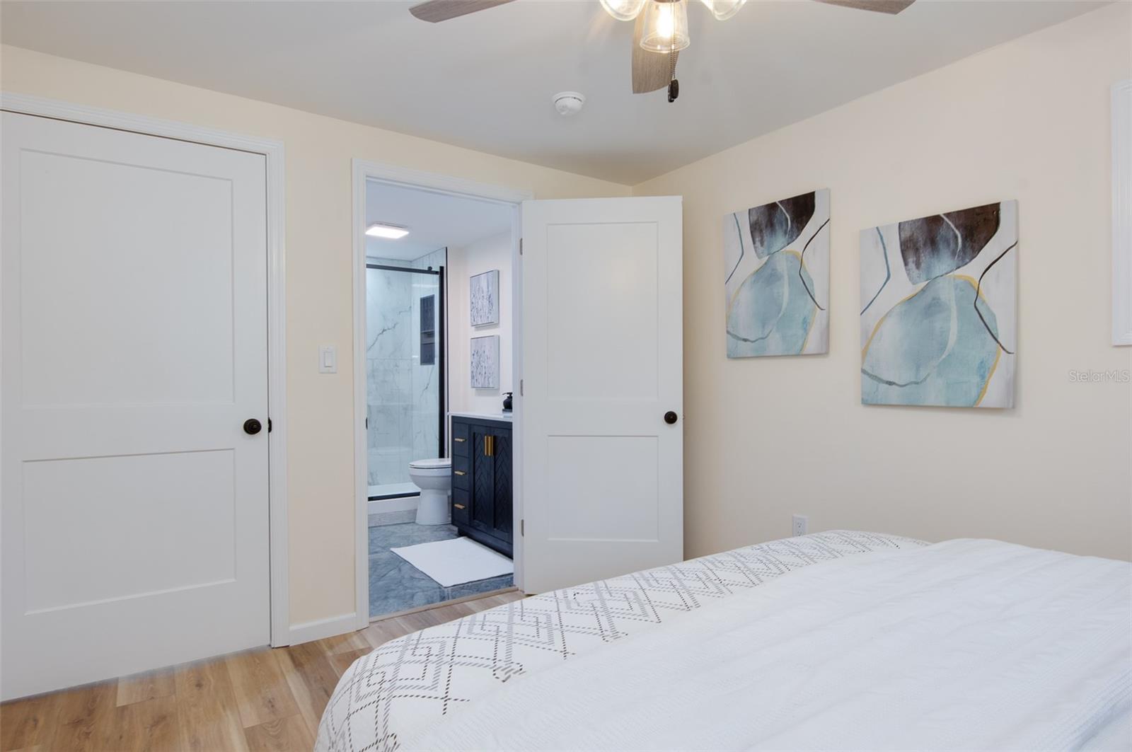 Primary bedroom with view of bathroom