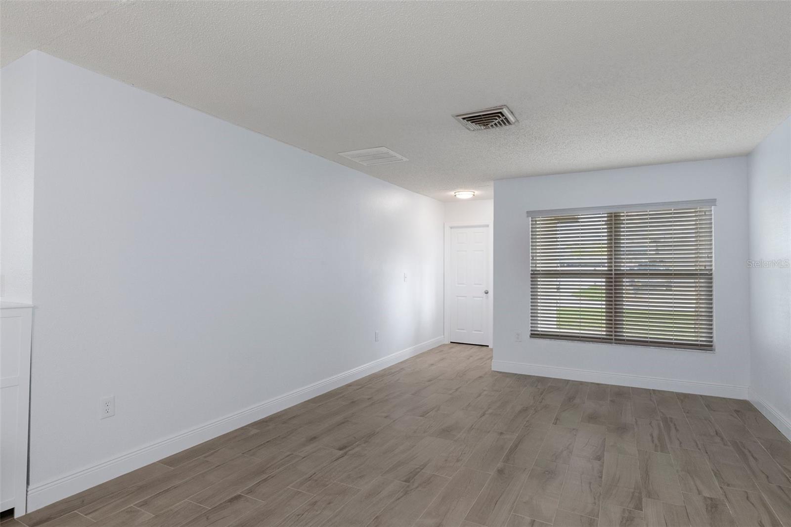 Front Formal Living Room with NEW Wood Look Plank Tile and Storage Closet