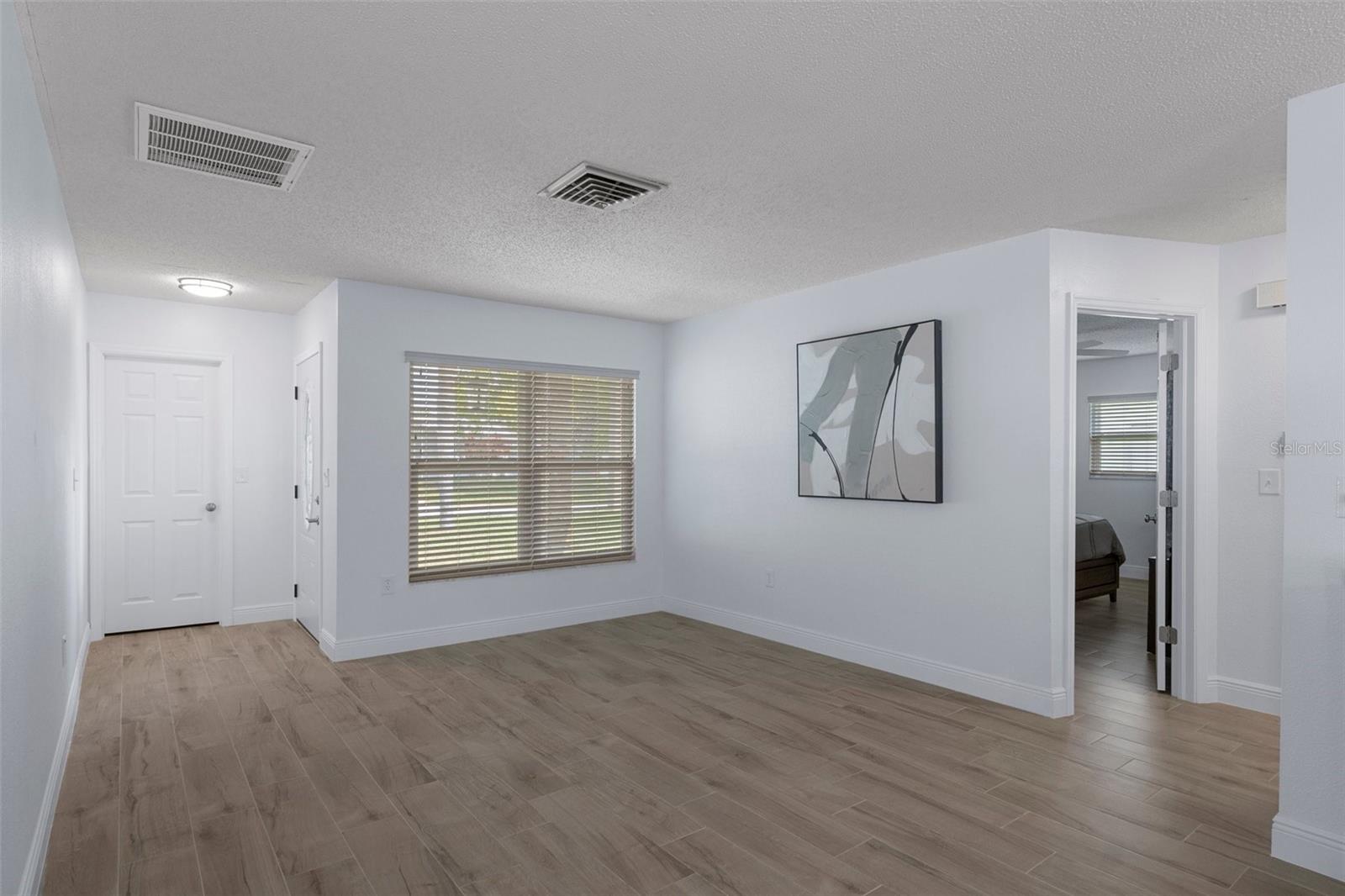 Front Formal Living Room with NEW Wood Look Plank Tile and Storage Closet